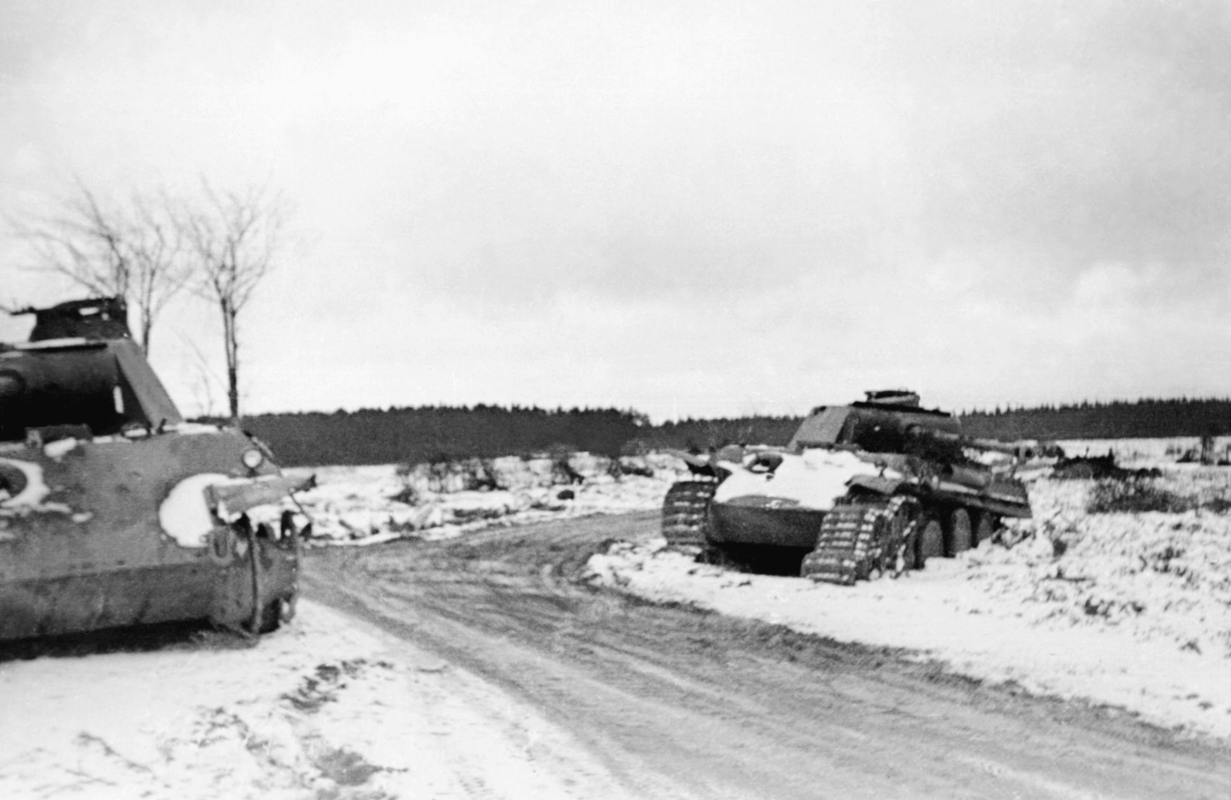 The battered hulks of Panther tanks 127 (left) and 135 lie abandoned at Lausdell crossroads following the heavy fighting of December 17-18, 1944. The Panther was developed in response to the Soviet T-34 in the East and far outclassed Allied armor on the Western Front.