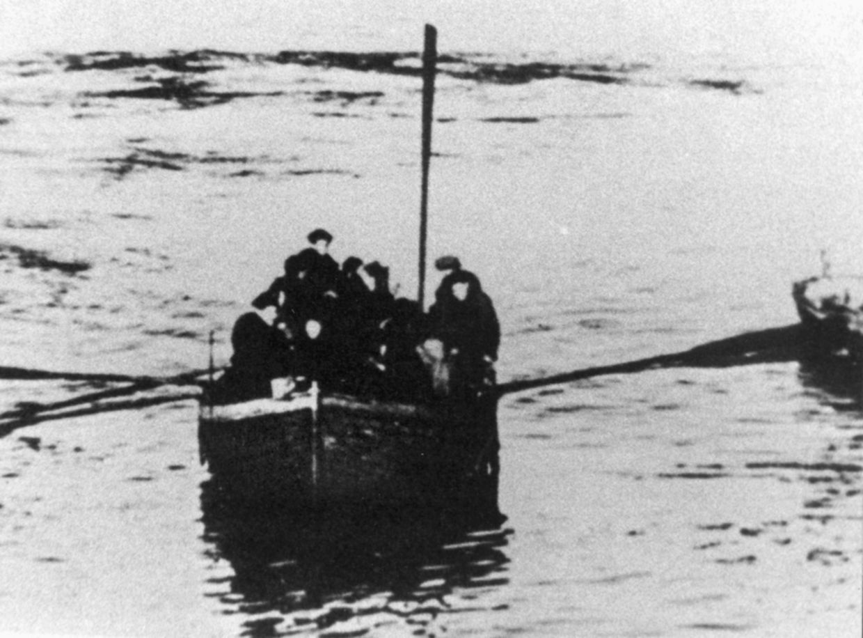 Their ship sunk beneath them, a group of sailors awaits rescue from icy arctic waters. Seamen drifting in rafts or lifeboats were plucked from the ocean by both Allied and German rescuers; however, many succumbed to the harsh conditions or the cold of the sea in which a man would be rendered unconscious within minutes. 