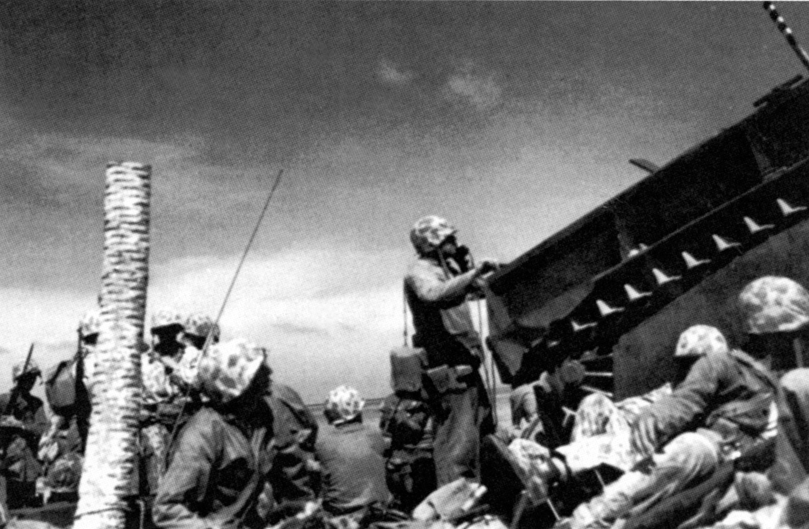 Using a field telephone, Marine Major Jim Crowe shelters behind LVT-23 and directs tactical movements against Japanese positions at Tarawa.  