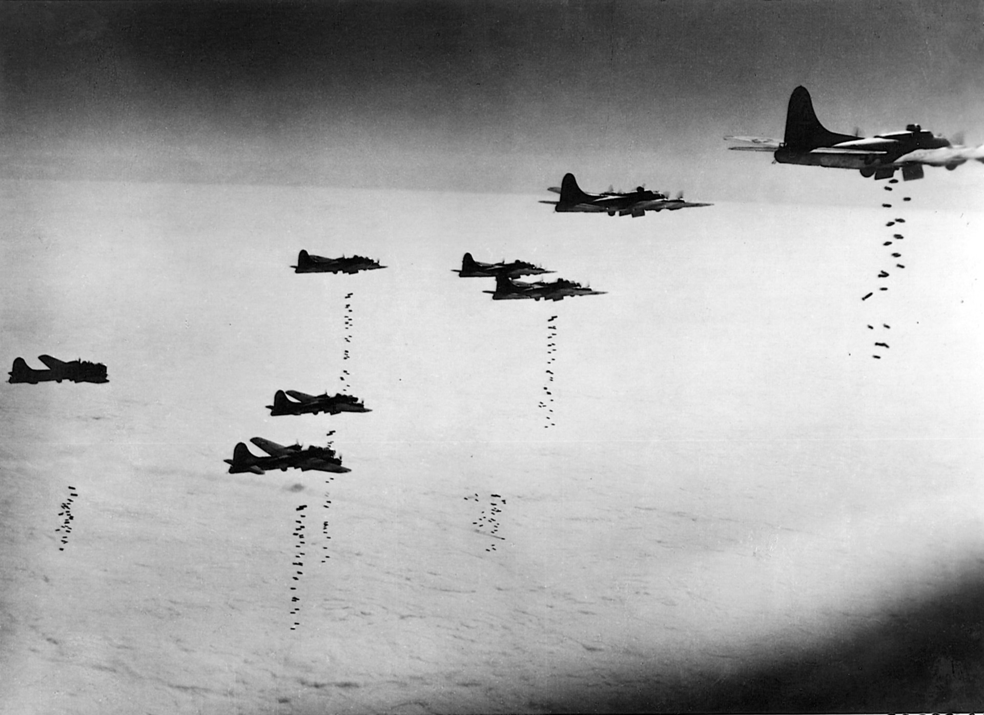 A formation of B-17s sends its bombs away on a cloudy day in March 1945. Such weather conditions required the target be fixed by radar. 