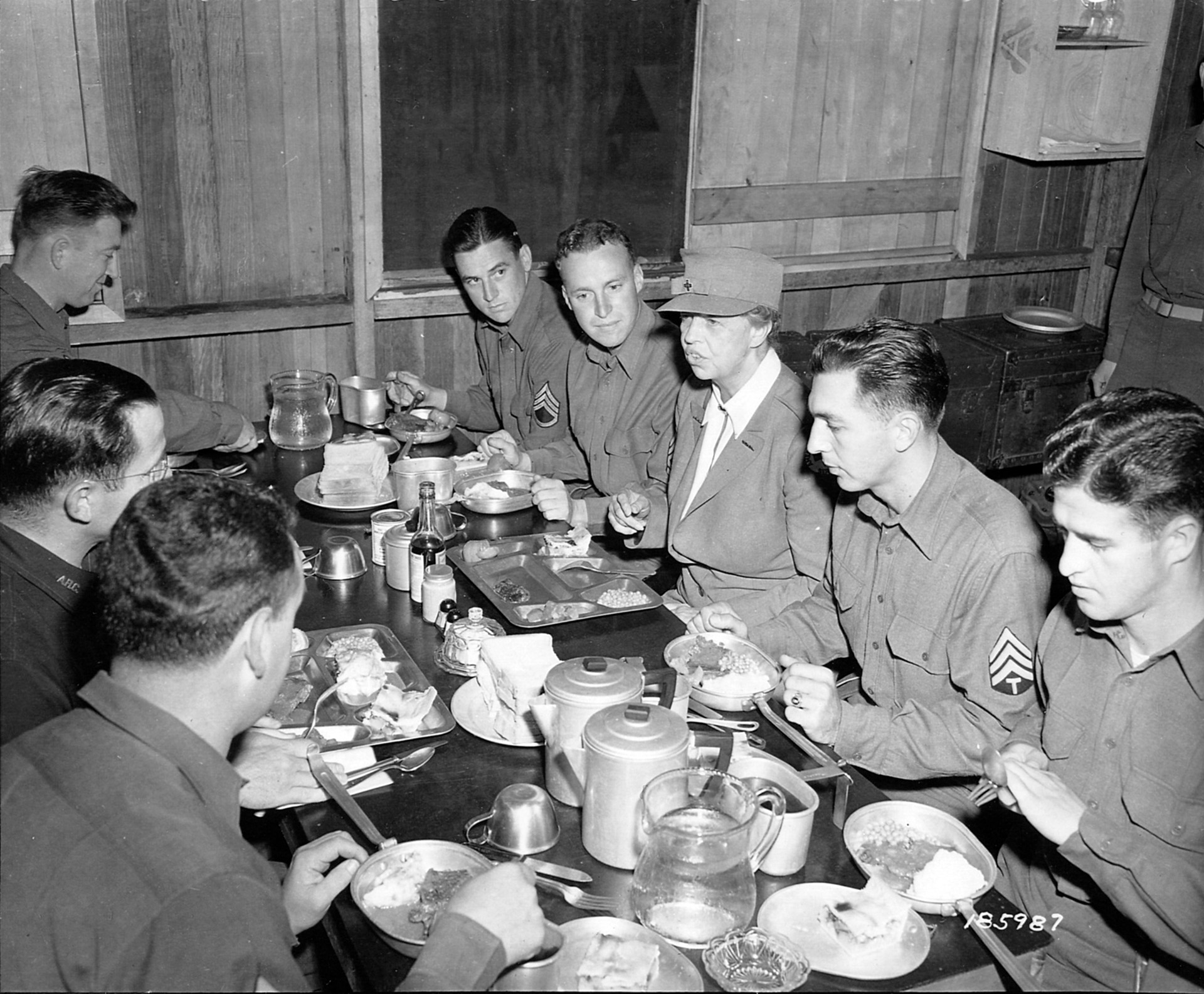 Sharing a meal with a group of NCOs of the 32nd Infantry Division in the Gilbert Islands, Eleanor Roosevelt displays her ability to communicate effectively, 1943.