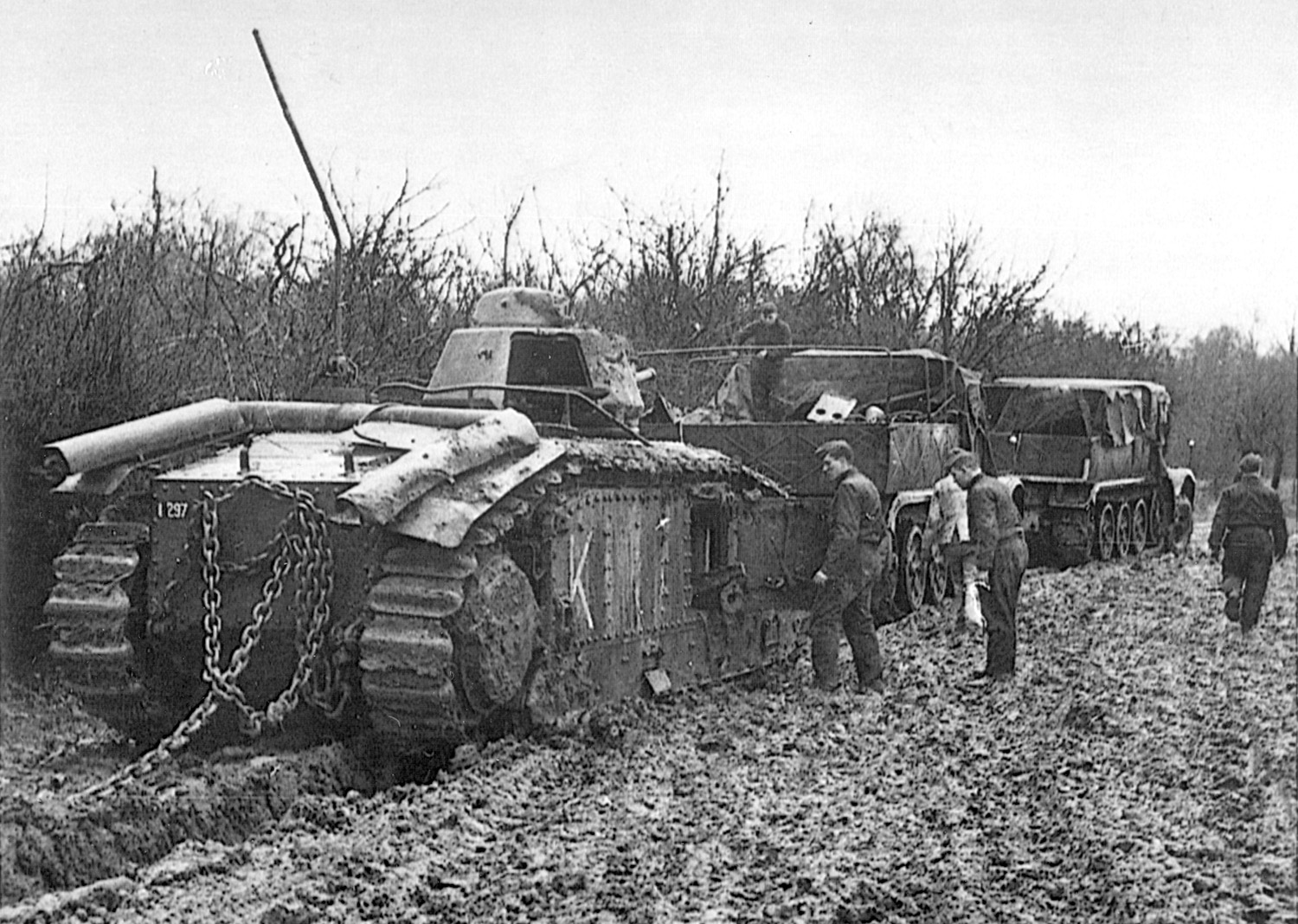 The spoils of war, abandoned French tanks are towed to a railway station for transport to Germany. Along with thousands of men killed, wounded, or captured, the Allies lost vast quantities of war materiel with the fall of France.
