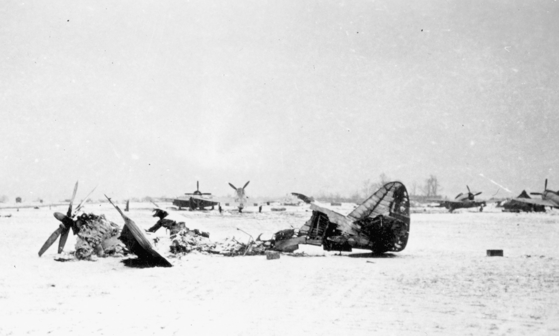 A P-47 of the 368th Fighter Group lies shattered at its base in Metz, France, following an early morning German raid. 