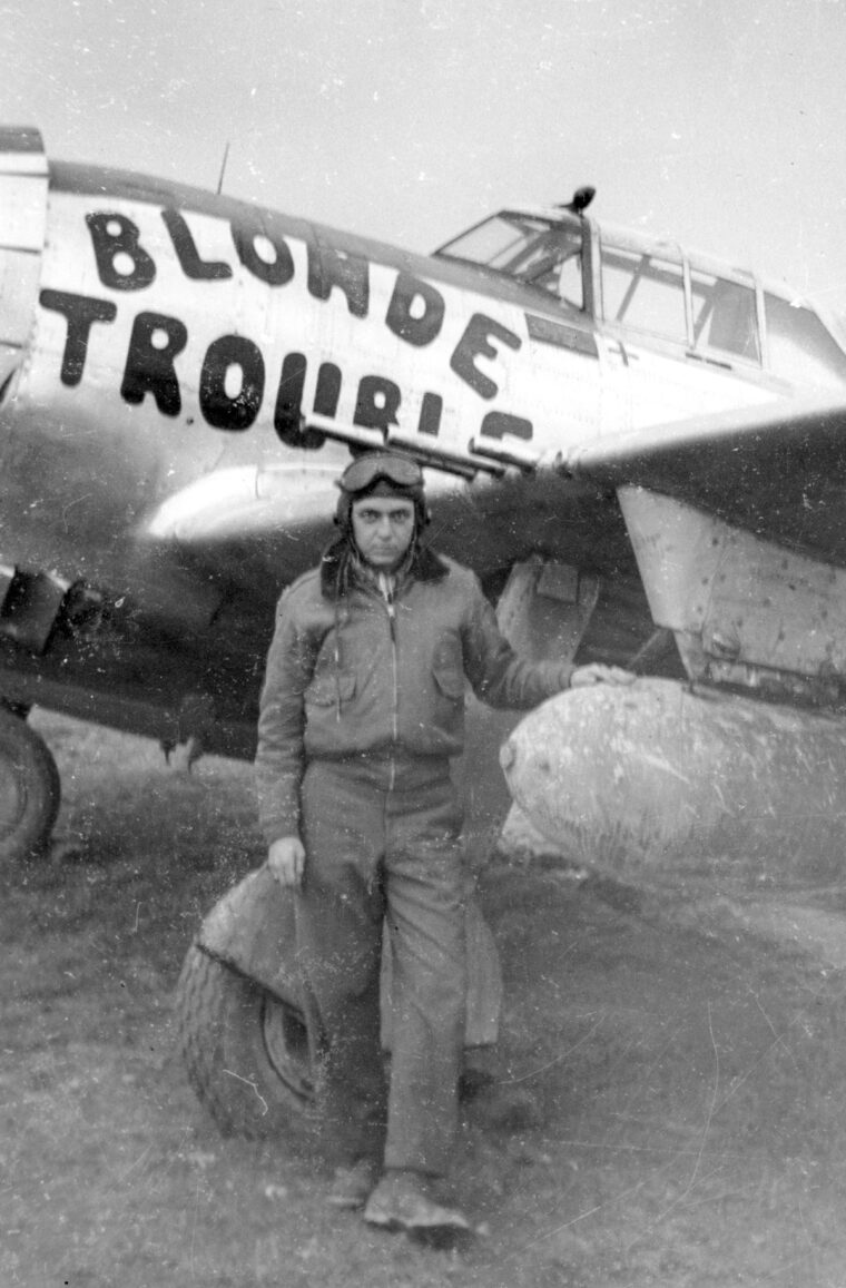 First Lt. Leslie Boze of the 365th Squadron, 358th Fighter Group, stands next to his mount, a P-47 nicknamed “Blonde Trouble.”