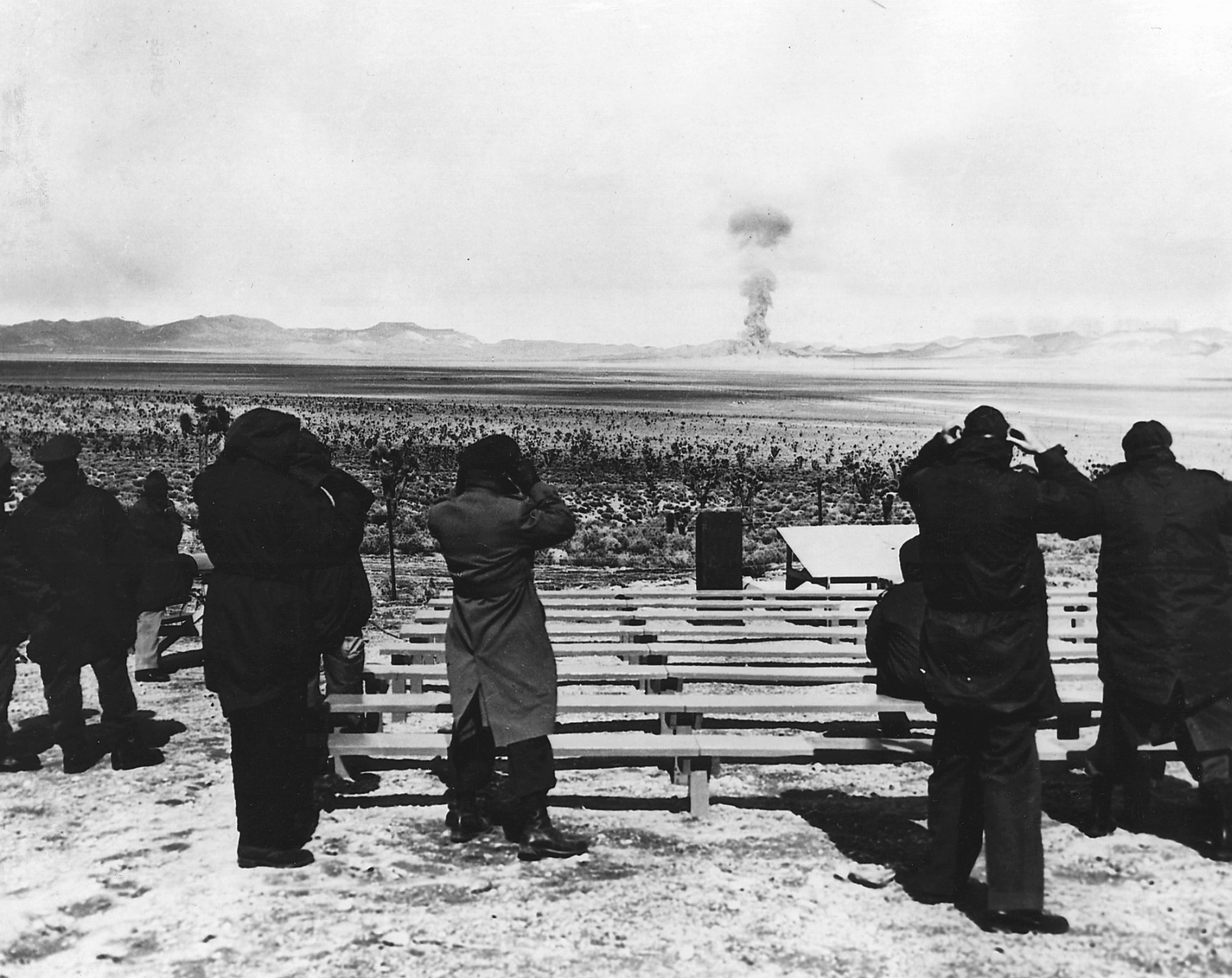 At a Nevada testing facility, the first shot of Operation Teapot is seen by official observers.