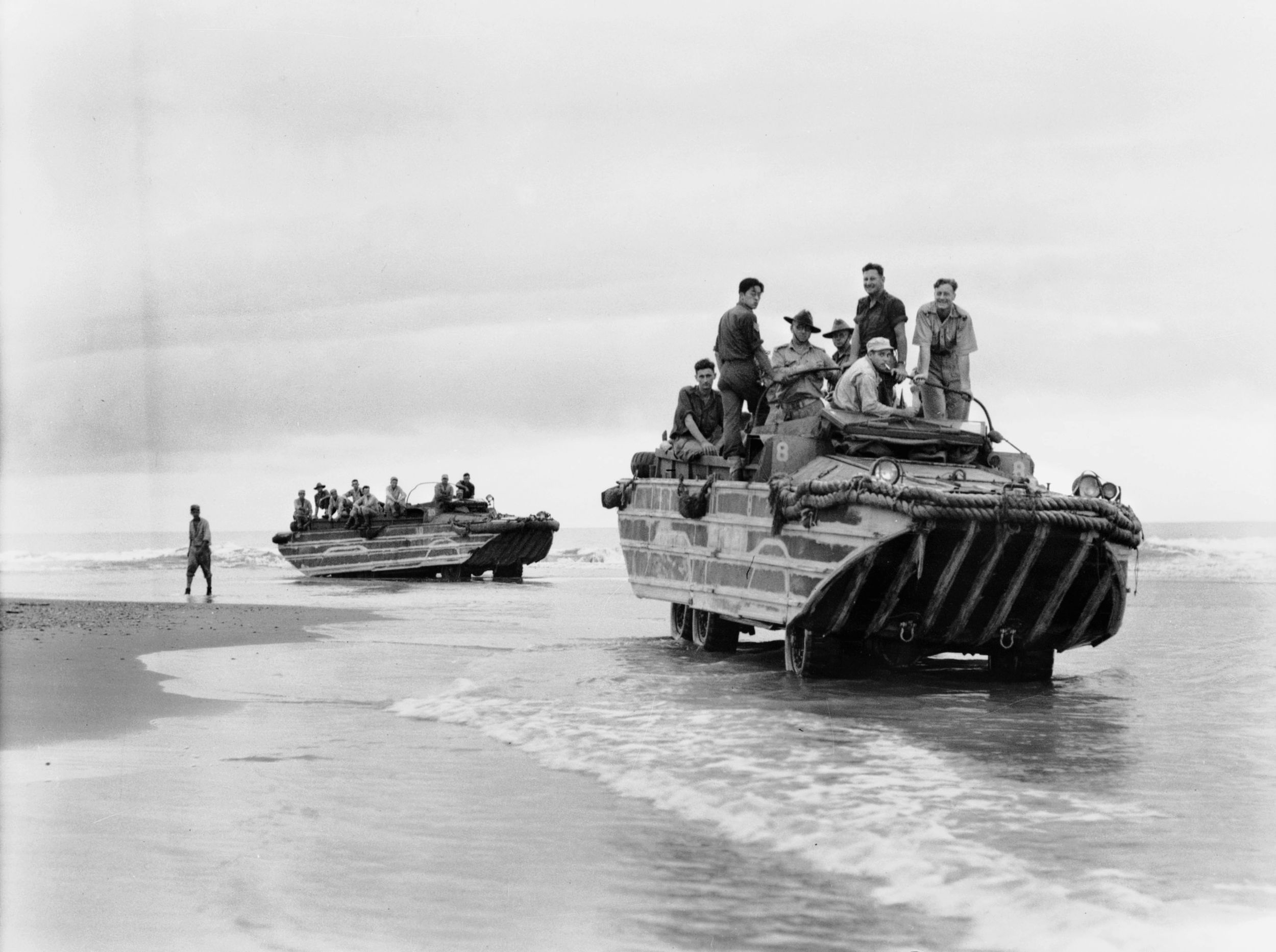 On July 11, 1944, soldiers of 2/10 Commando Squadron are shown hitching rides aboard American-built amphibious DUKW craft as they deploy to Babiang, New Guinea.