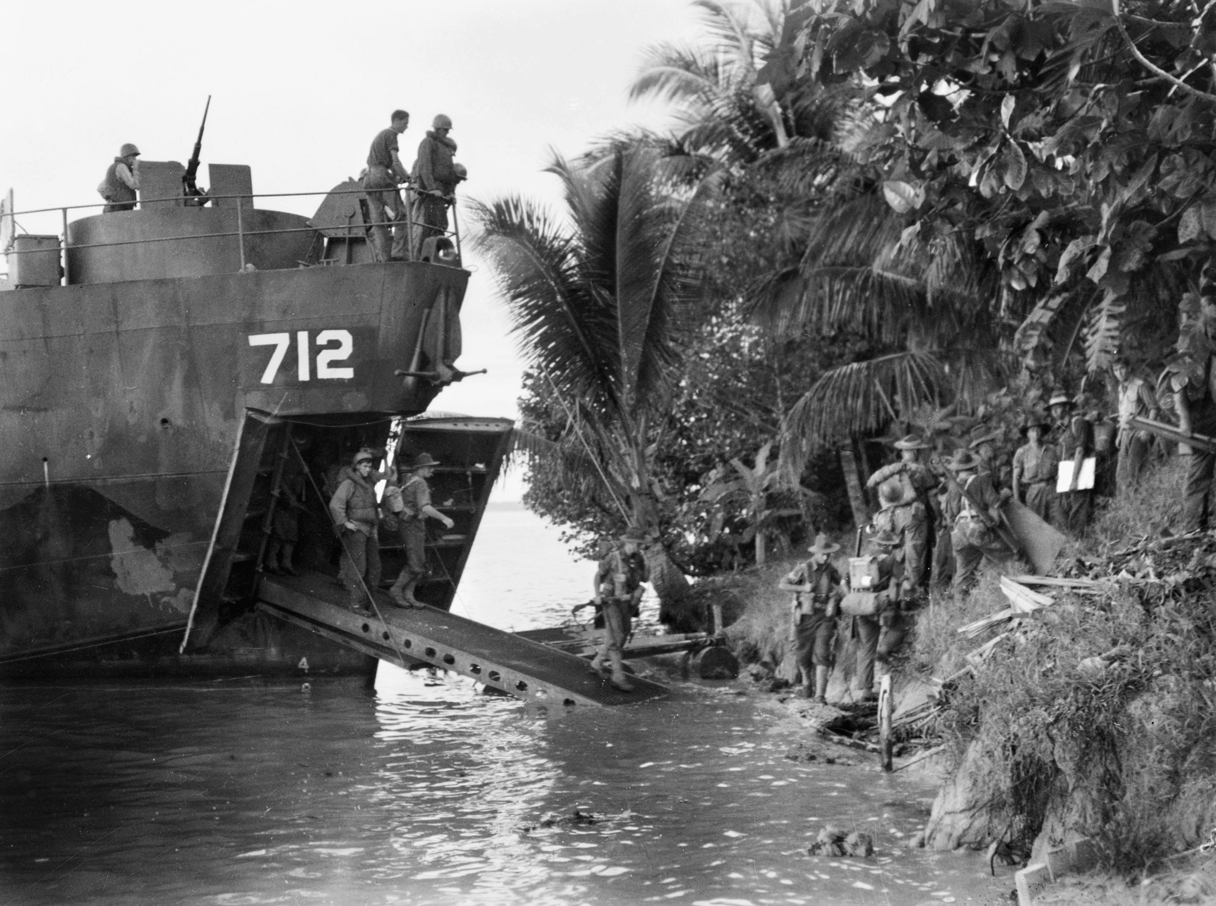 Piling out of a landing craft unopposed at Sadau Island, Borneo, on April 30, 1945, troopers of 2/4 Commando familiarize themselves with their surroundings. No resistance from the Japanese was encountered on the island, and the Australians suffered no casualties.