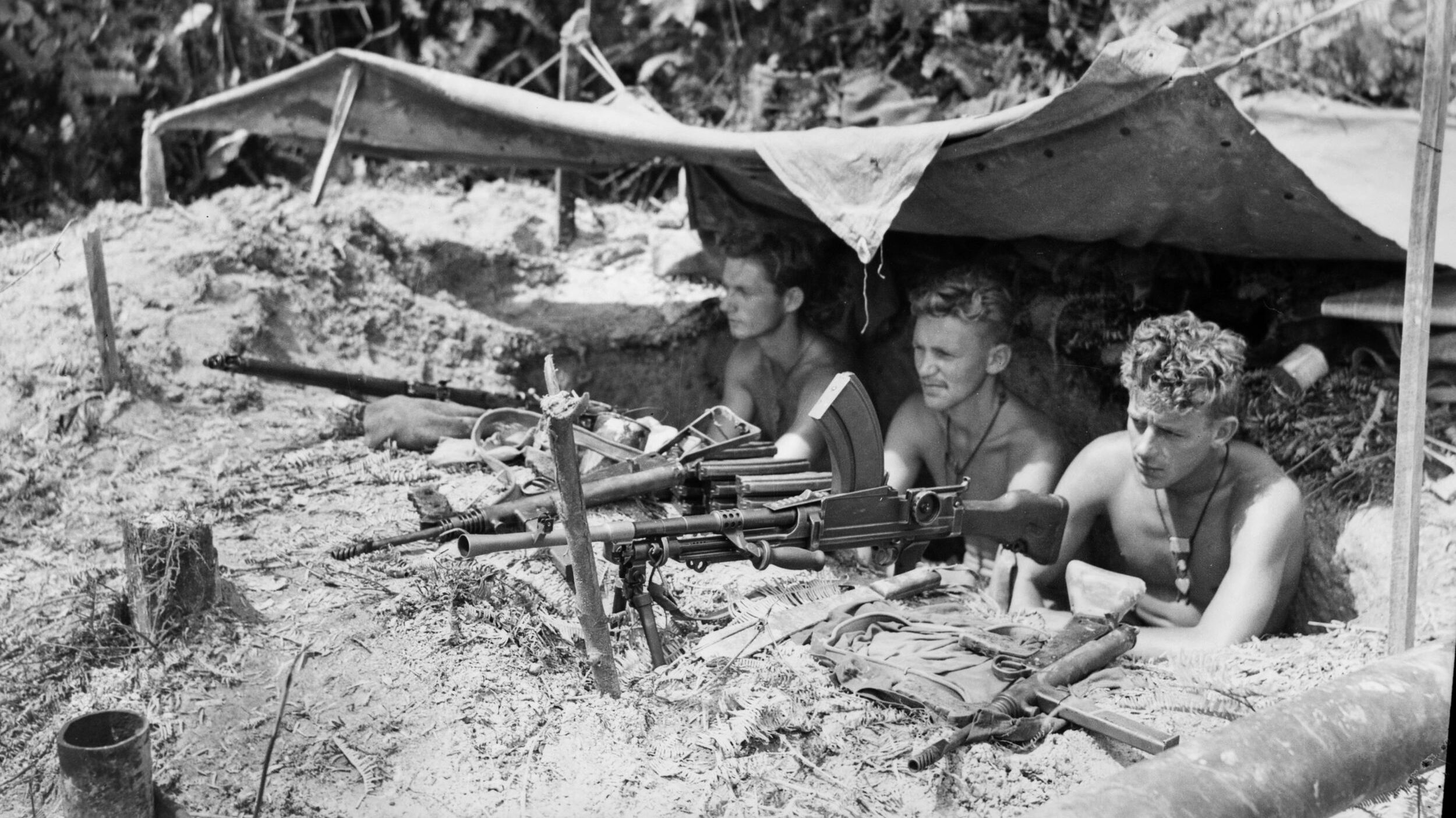 Manning a Bren gun position along the forward line of C Troop, 2/4 Commando Squadron covering an area known as Snags Track, troopers McGowan, Sherring, and McDonald cast a wary eye toward Japanese positions. These Australian commandos were ashore near Tarakan, Borneo, on May 13, 1945.