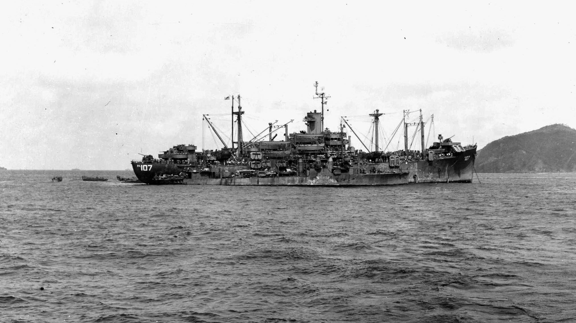 The destroyer USS Howard comes alongside the attack transport USS Goodhue, which lies at anchor. The Goodhue was among hundreds of U.S. Navy ships that were assailed by Japanese kamikazes off Okinawa in April 1945. 