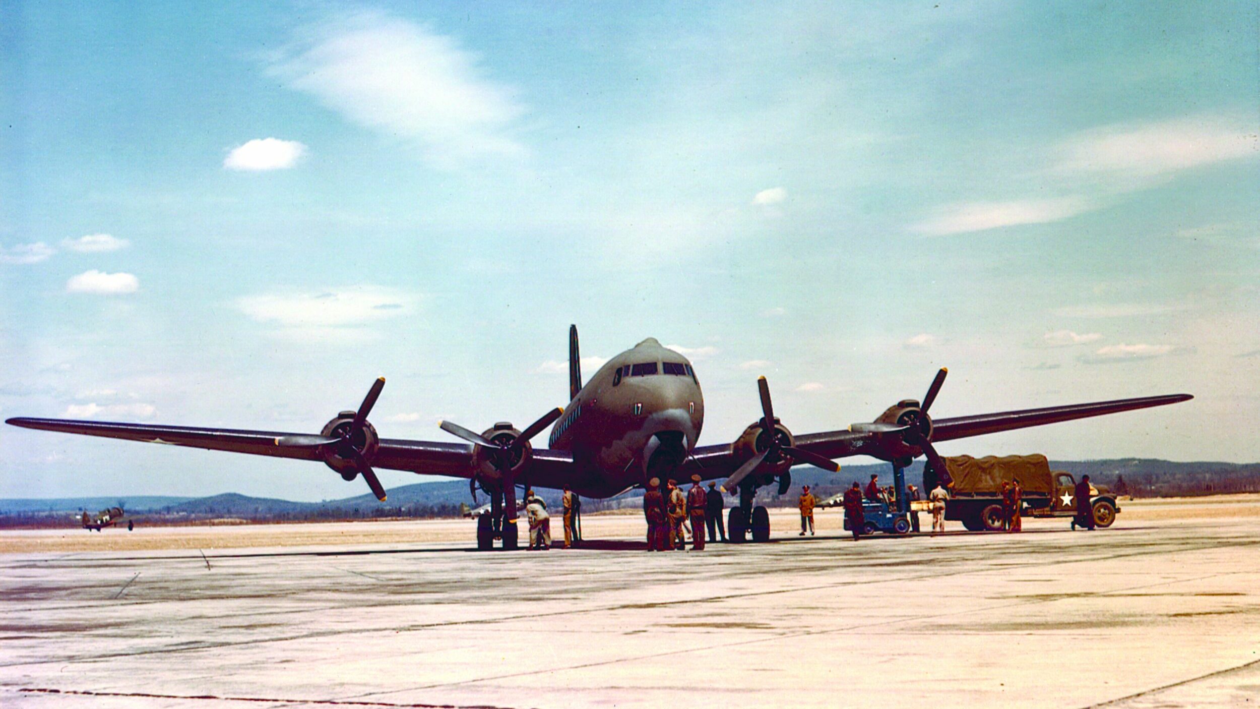 A C-54 cargo plane is loaded with supplies for the long journey across the mountains to China. After the Japanese had cut overland supply routes, the only method of transportation that could be counted on was through the air.