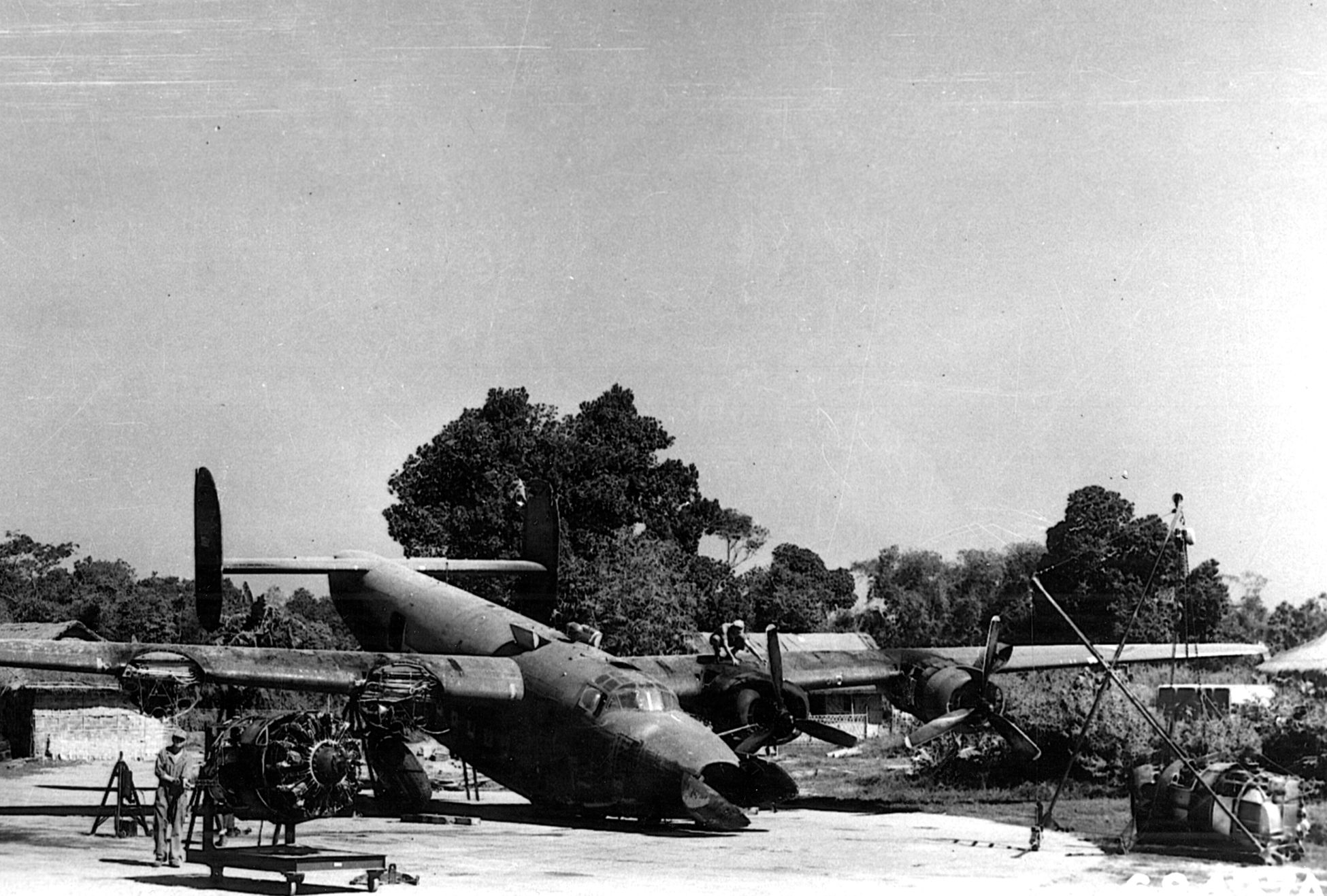 A C-87 transport, which has crashed at an airfield in India, is salvaged by ground crewmen in the hopes that it will be airworthy once again. The C-87 was the transport version of the B-24 Liberator heavy bomber. 