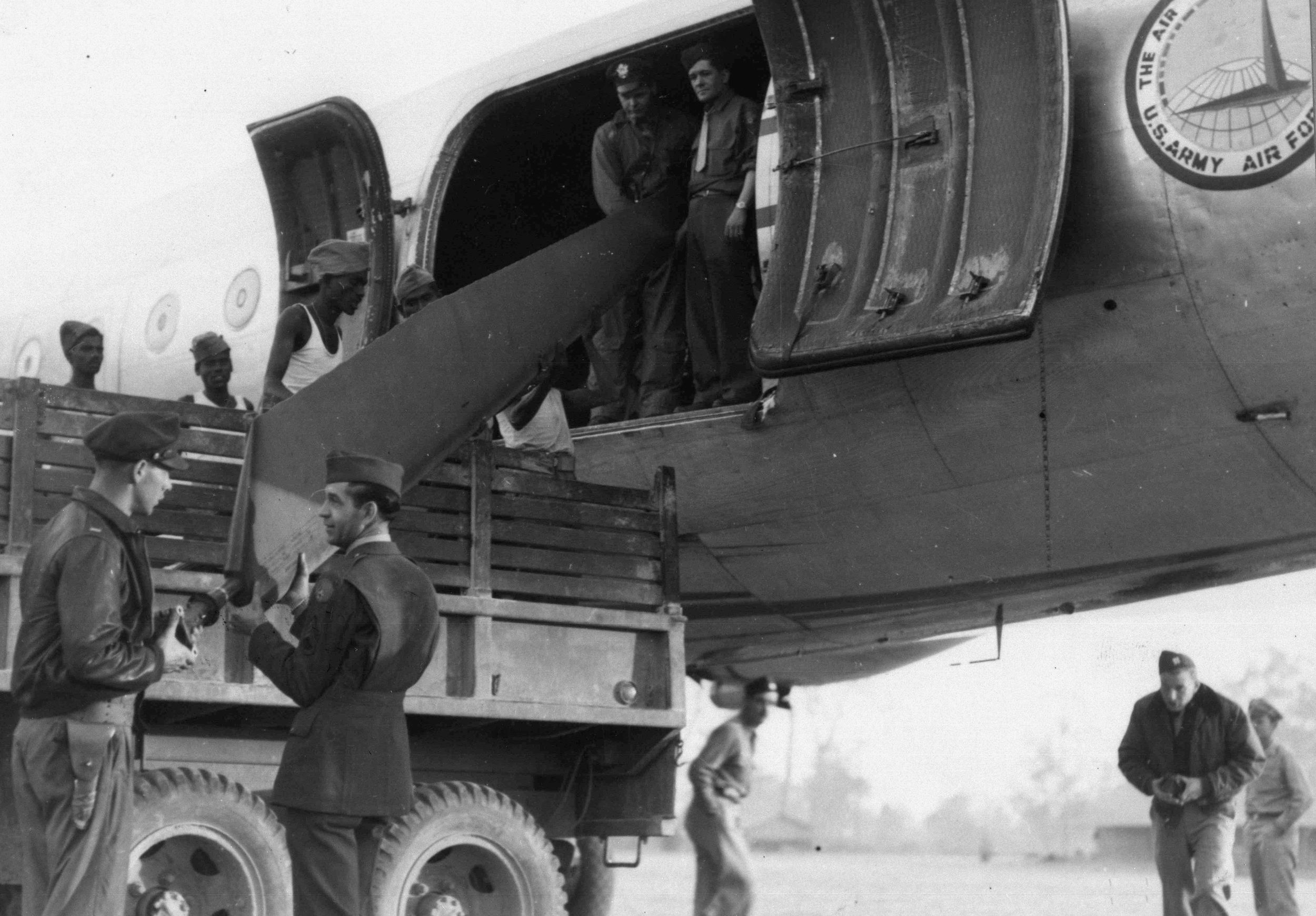 At Myitkyina, Burma, a helicopter is unloaded from a Douglas C-54 of the Air Transport Command. The helicopter saw limited use in the China-Burma-India Theater during World War II.