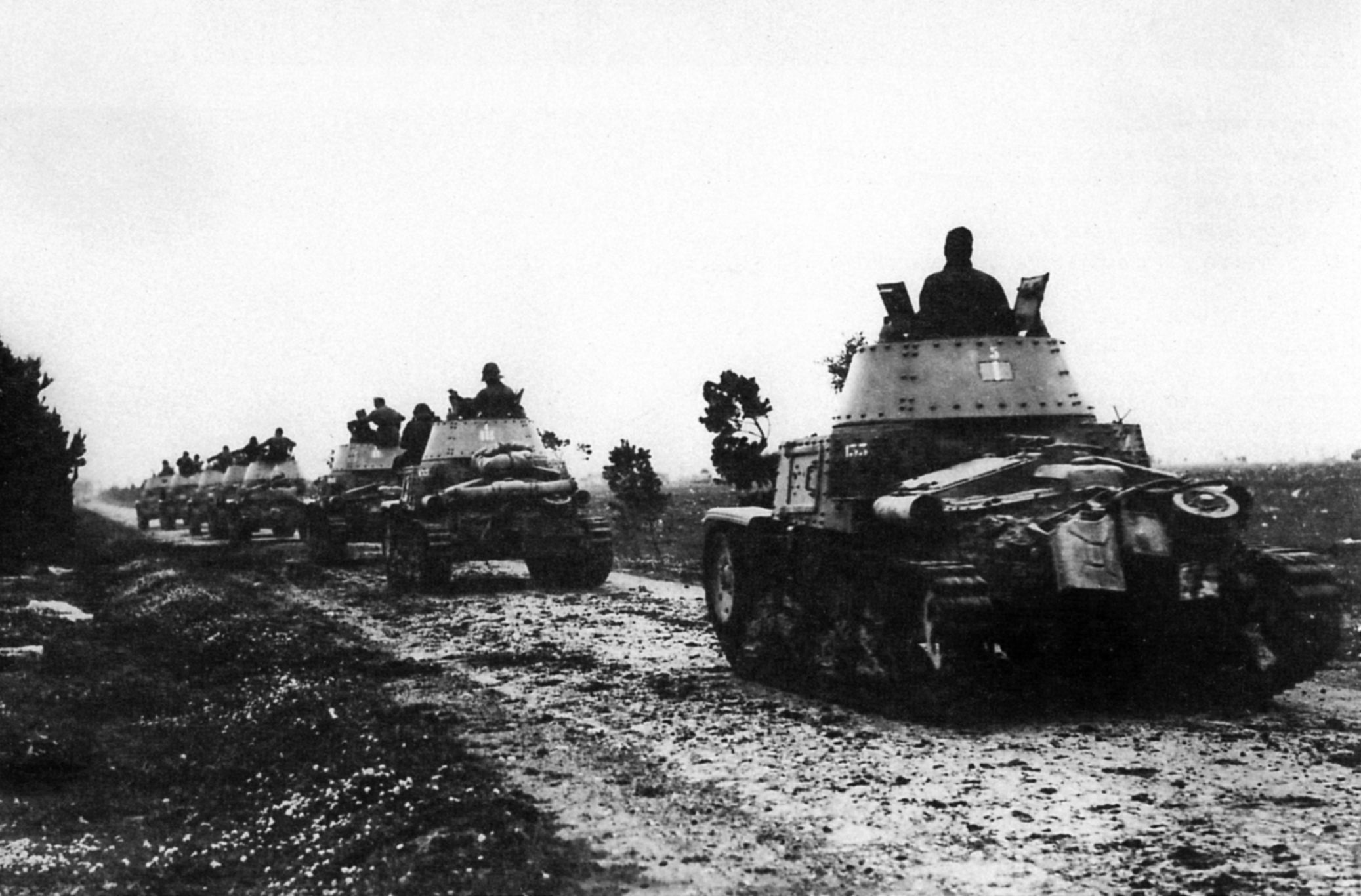 Moving toward the front in the Libyan desert in 1940, a column of M14/41 medium tanks of the 133rd Tank Regiment of the Littorio Armored Division raises a cloud of dust.