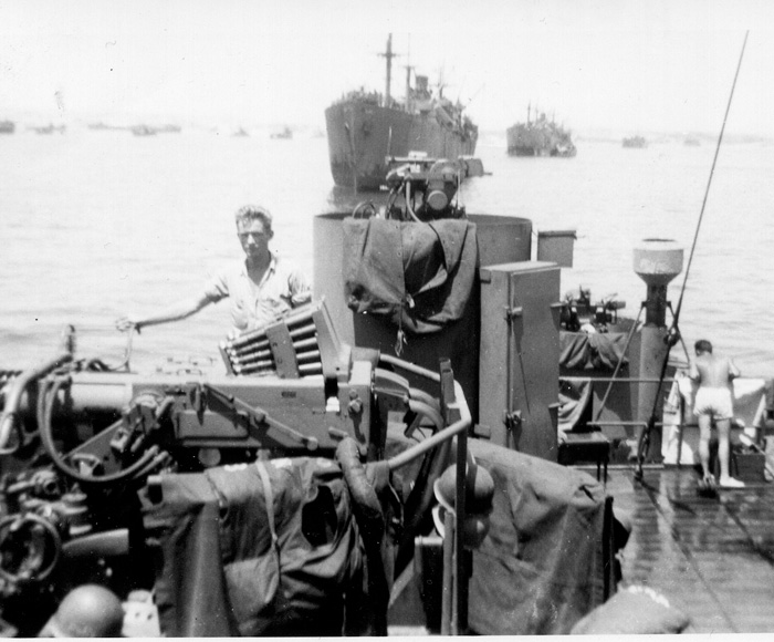 Crewman Robert Guenther is photographed next to a twin 40mm mount on the ship’s aft superstructure during the spring of 1945.