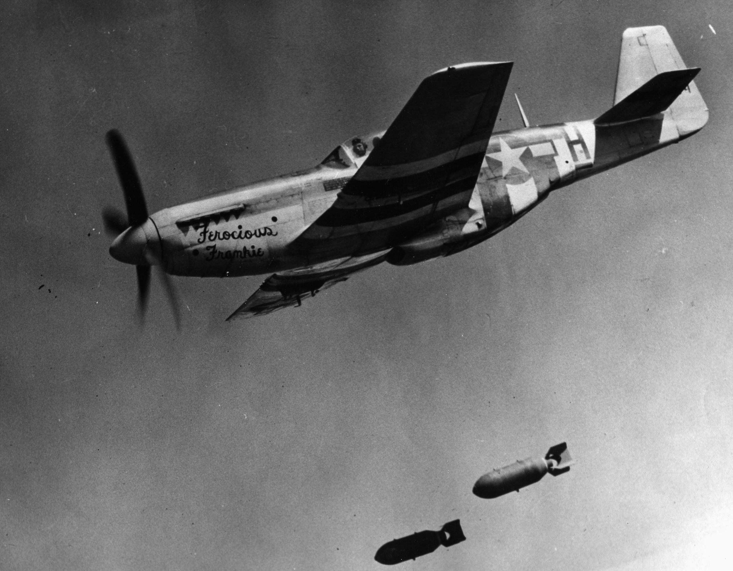 During a fighter bomber mission, Lieutenant Colonel Wallace Hopkins of 8th Fighter Command releases his bomb load from his P-51 Mustang nicknamed “Ferocious Frankie.” The Mustang proved capable in both the escort and ground attack roles.