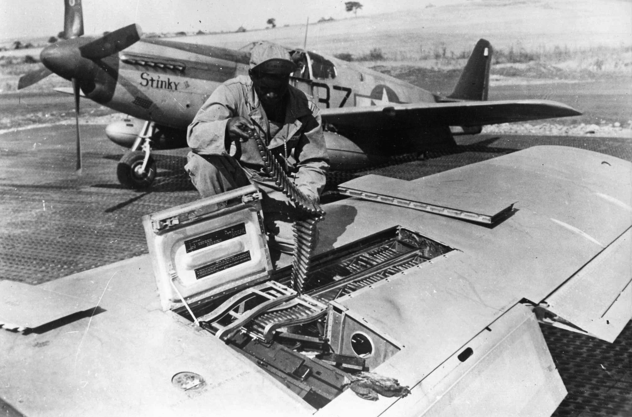 A Fifteenth Air Force armorer loads a belt of ammunition for one of a Mustang’s six .50-caliber machine guns. Flying from its base in Italy, this fighter plane was being readied for a mission over Germany.  Often, when escort duties were completed, the Mustangs were allowed to seek targets of opportunity.