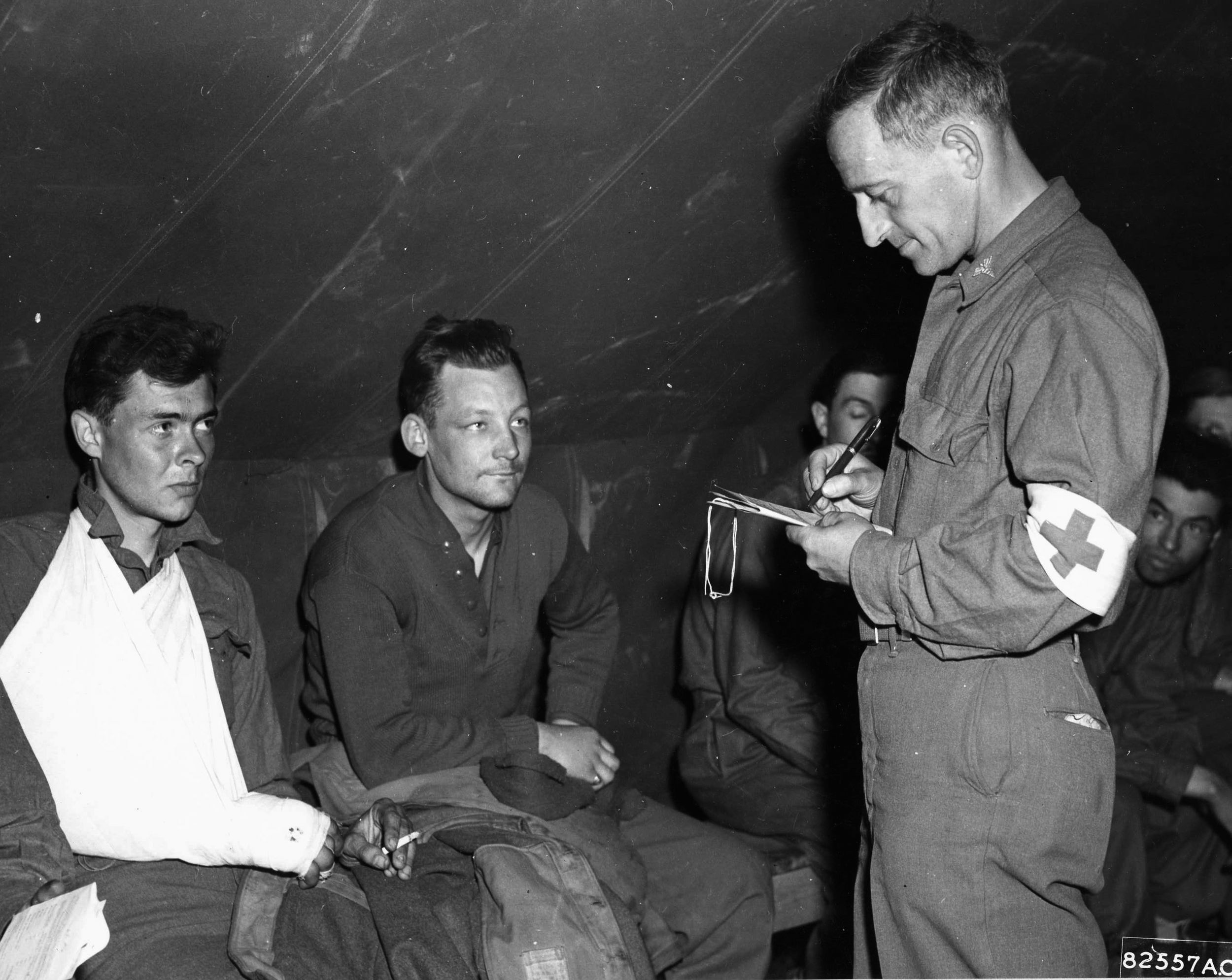 On April 27, 1945, liberated prisoners of war have their identification checked by members of the U.S. Army Medical Corps. The former POWs were then evacuated by aircraft of the 9th Troop Carrier Command.