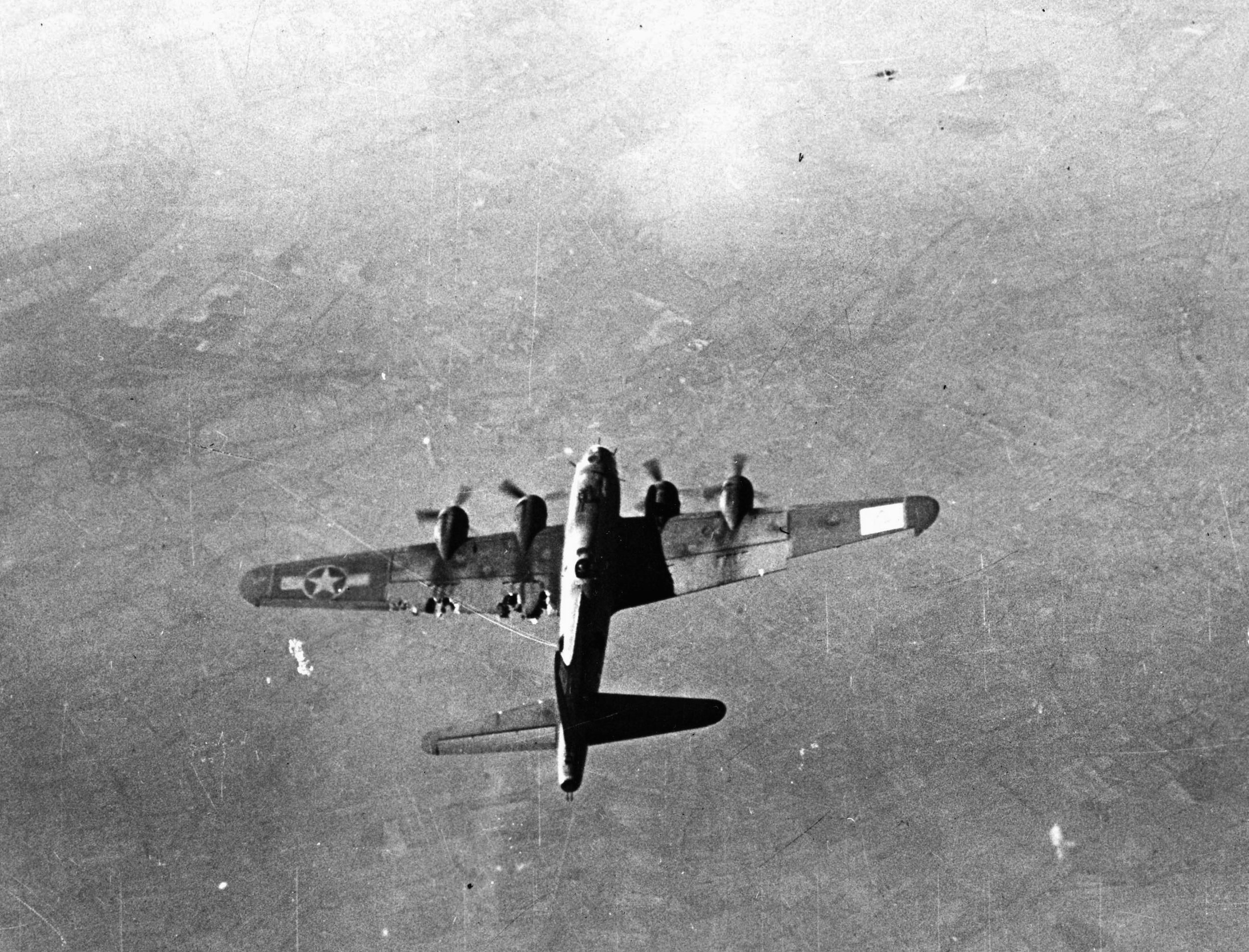 Having sustained visible damage to its left wing either from thick German flak or marauding Luftwaffe fighters, this B-17 bomber nevertheless maintains formation during the bombing run on a mission against the communications center of Gelsenkirchen, Germany. (National Archives)