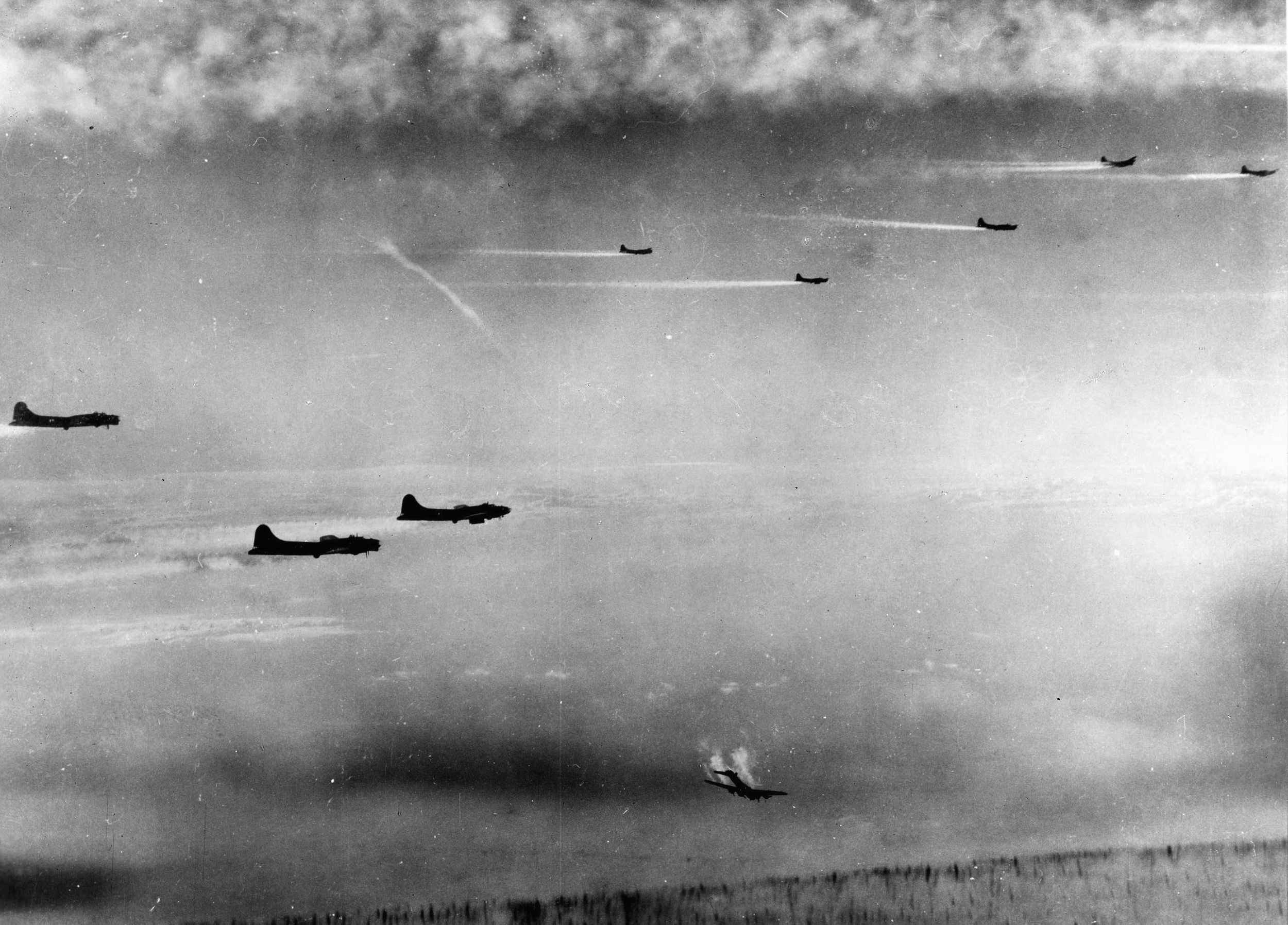 A photographer of the Eighth Air Force captured this haunting image of a B-17 streaking earthward as smoke streams from its engines while the remaining bombers in the frame continue toward their target, the city of Bremen. The tail assembly of the stricken B-17 has apparently been shot away. (National Archives)