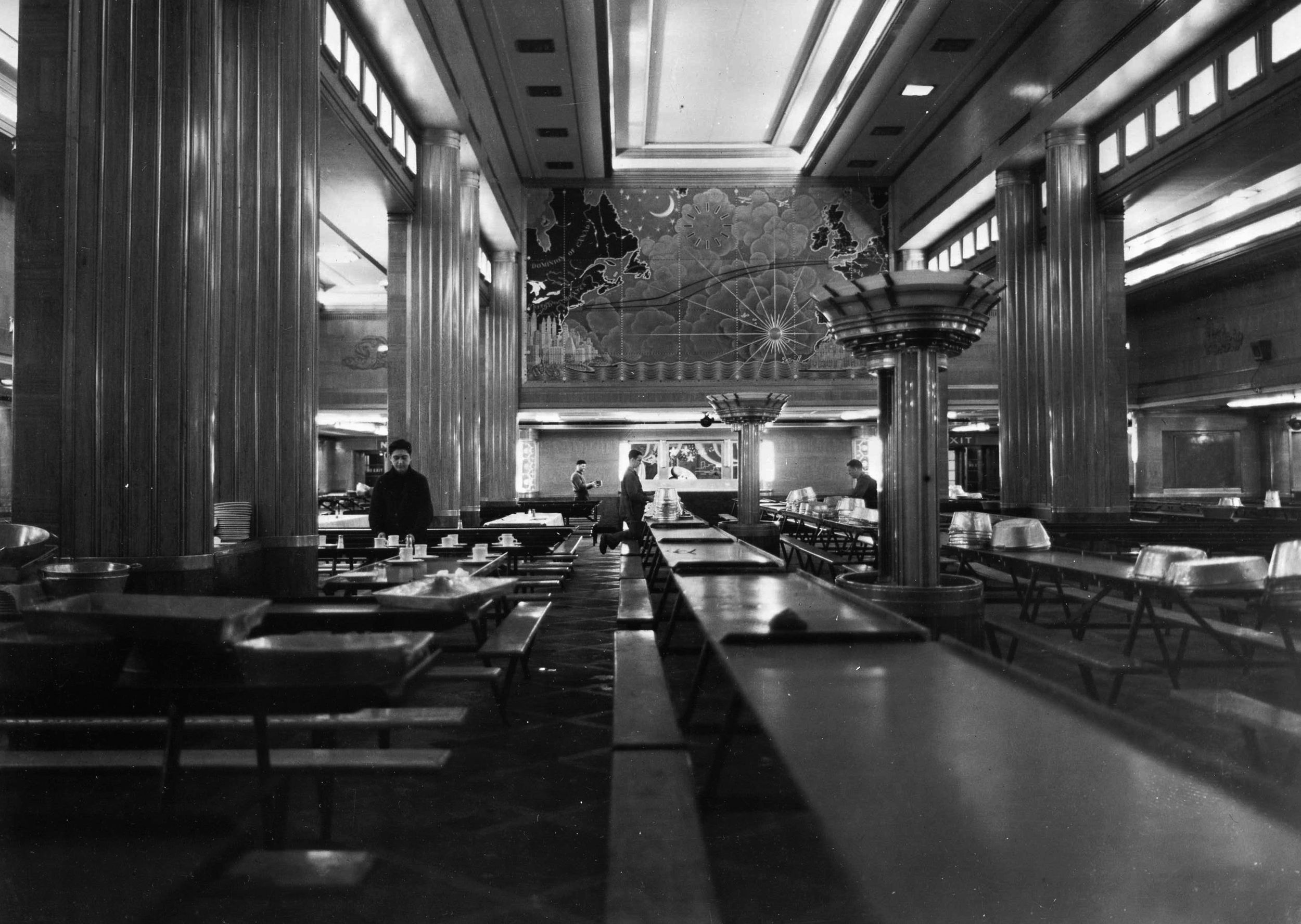 The peacetime opulence of the Queen Mary could not be hidden during the war. Here, the finery of the main dining room is apparent. Known to the troops the ship carried as the main “mess hall,” the area could accommodate 2,000 men at a single sitting. 