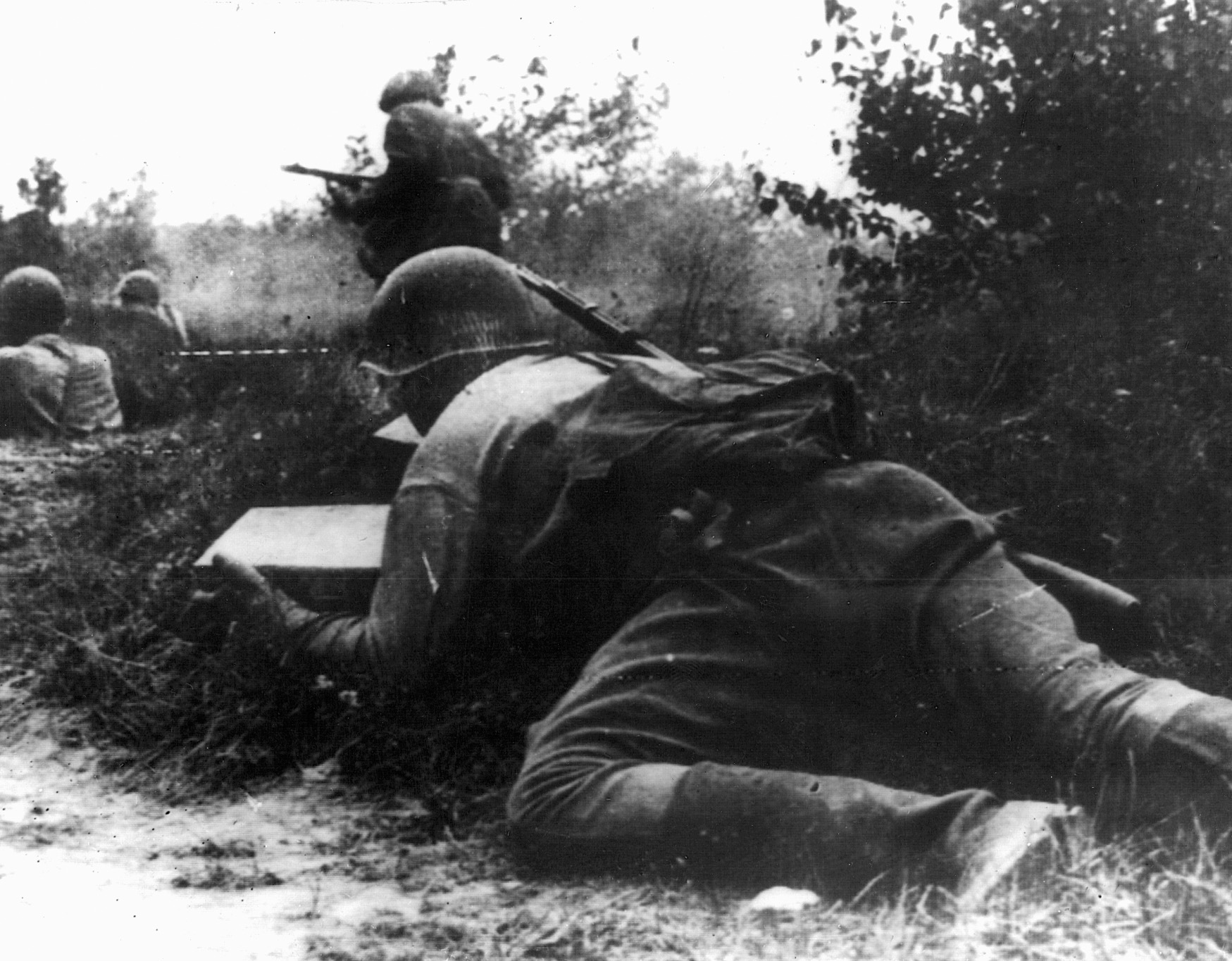 On August 12, 1942, a Red Army soldier crawls forward to deliver ammunition to comrades fighting to hold back a German counterattack on Soviet positions. 