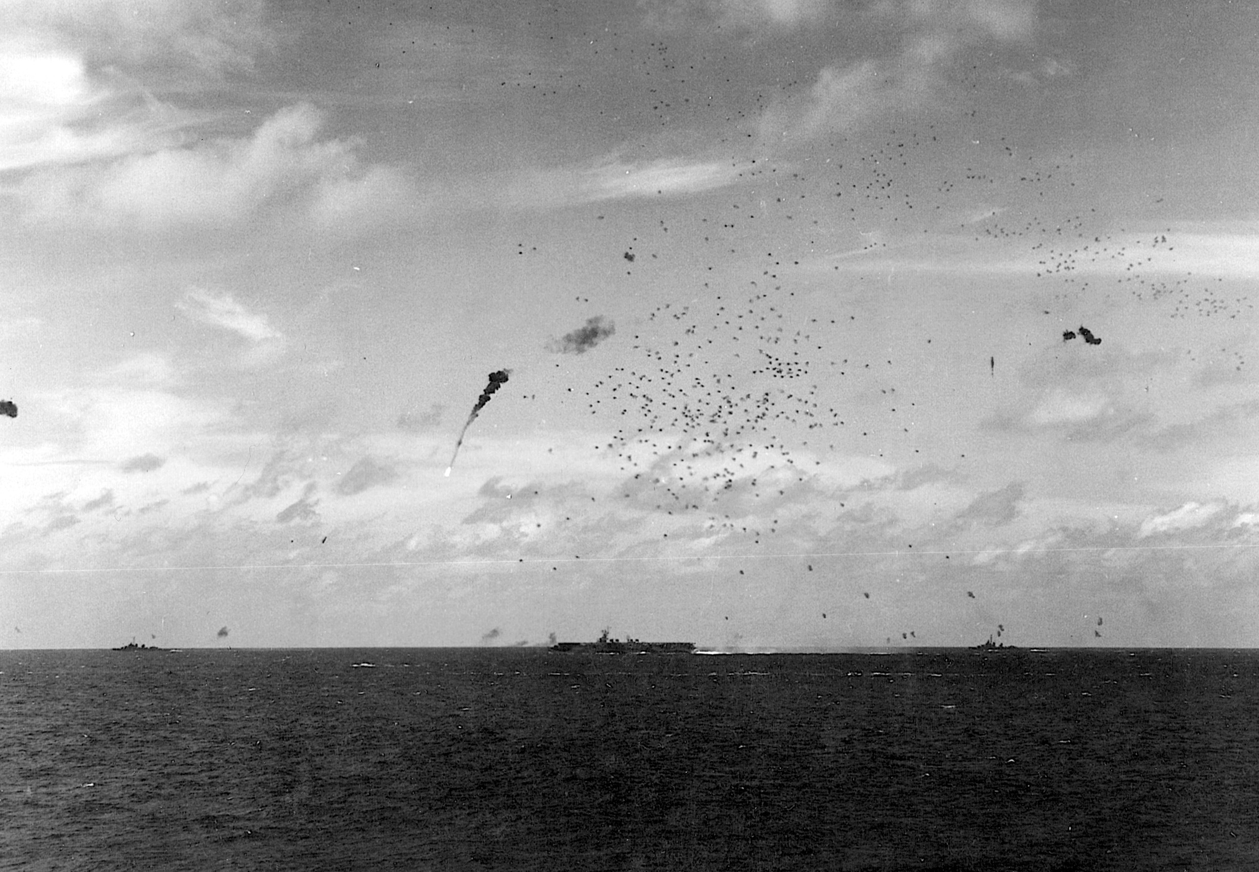 A Japanese plane bursts into flames as accurate antiaircraft fire from an American escort carrier sends it spiraling into the sea. 