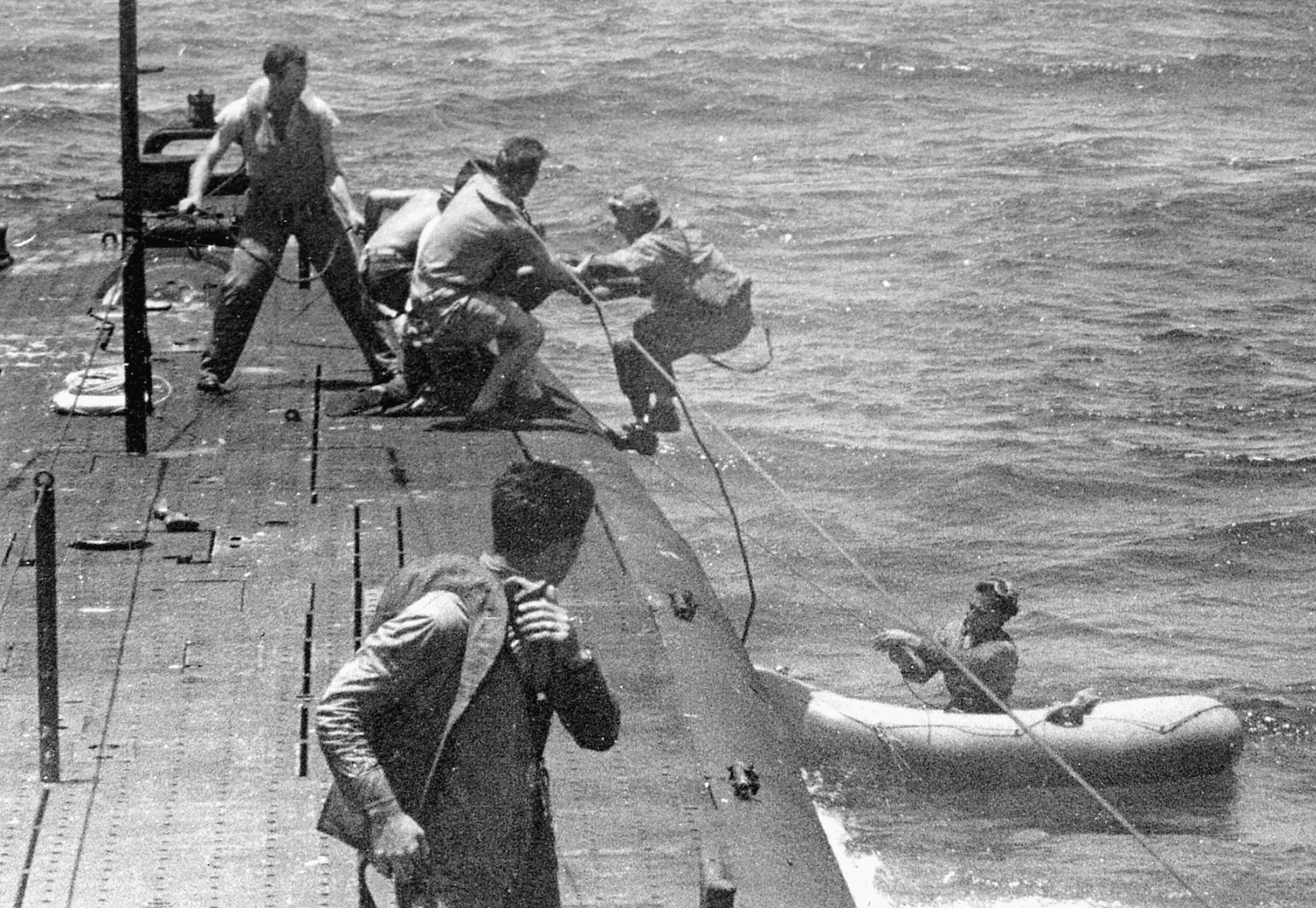 Downed pilots are pulled aboard the USS Tang. 