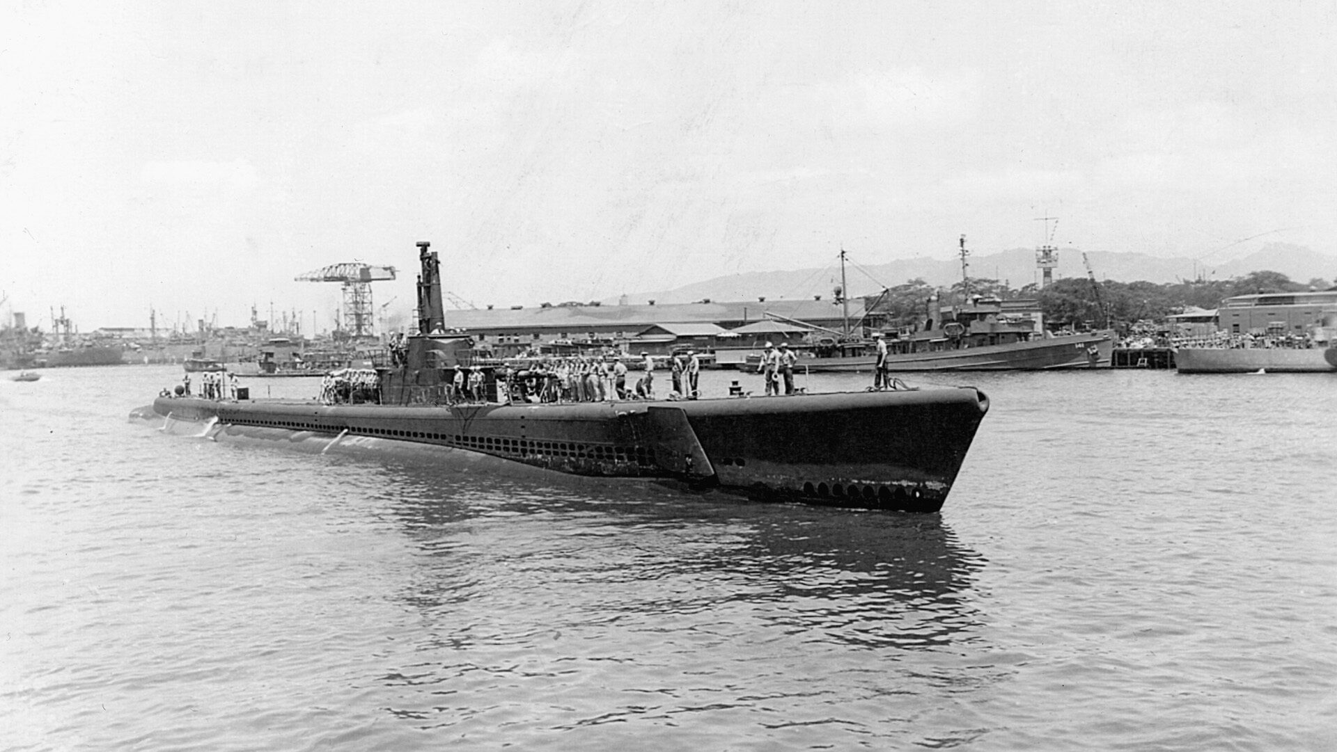 Making its way toward a berth at Pearl Harbor, the highly successful USS Tang comes into port.