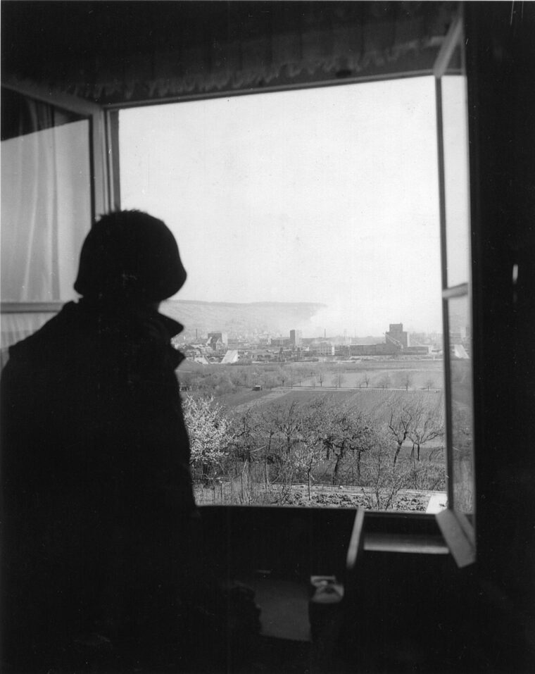 An American soldier looks out over Heilbronn from an observation post.