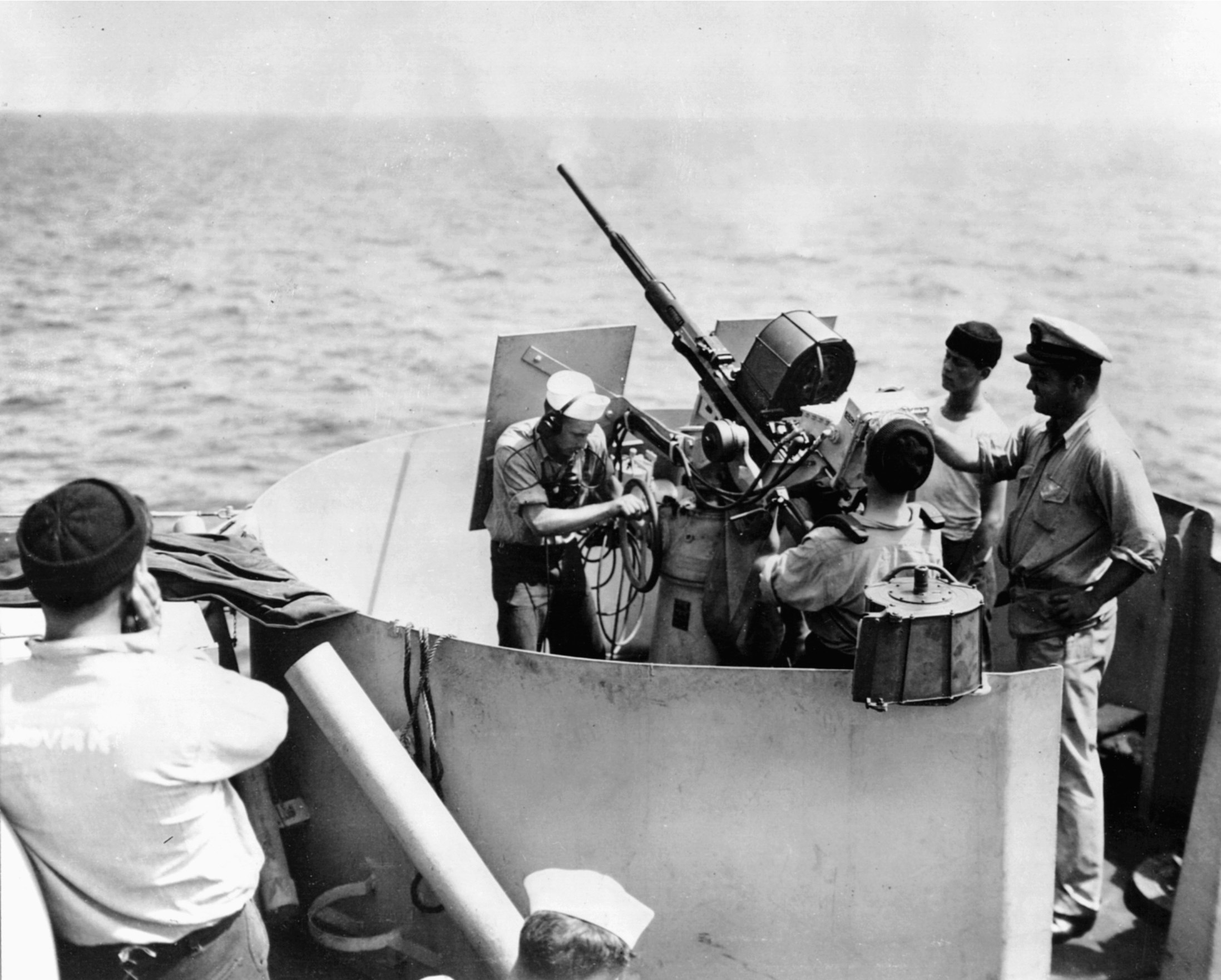 A 20mm Oerlikon cannon is shown in action aboard the destroyer escort USS Jacob Jones.