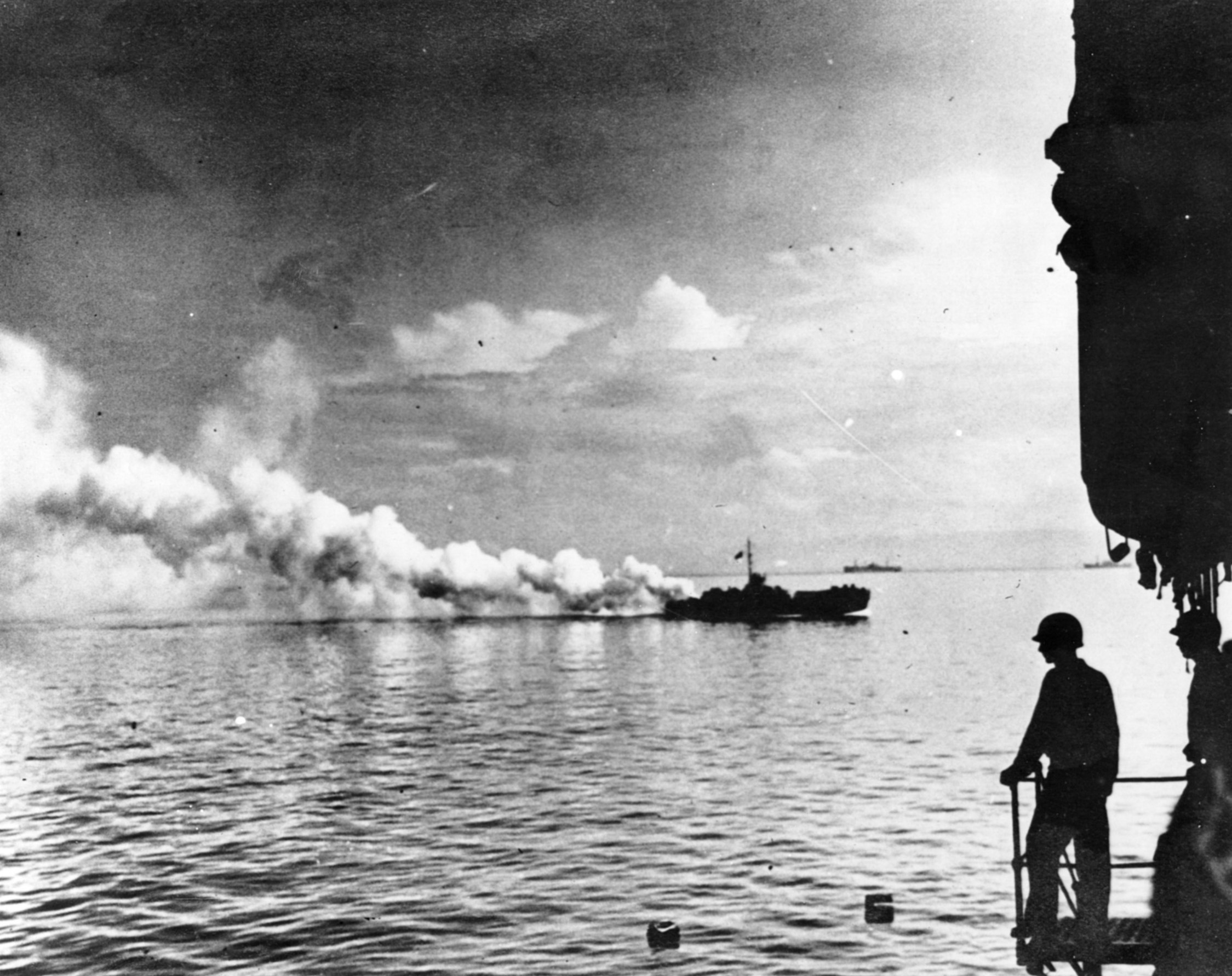 An LCI (landing craft, infantry) lays a smokescreen to provide cover for Allied vessels heading toward the shore at Leyte.