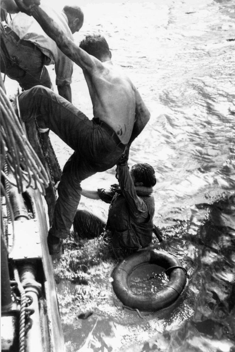 American sailors, who survived the sinking of their ship during the Battle off Samar, are shown here being rescued by another vessel after the Japanese force has withdrawn in the face of stiff resistance. 