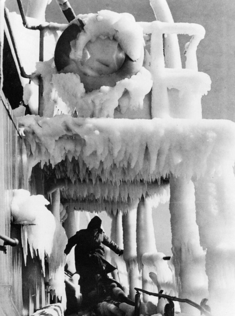 A seaman negotiates the slick deck of a merchant vessel coated with thick ice. If his ship were torpedoed, a sailor’s chance of survival in the icy waters near the Arctic Circle was slim.