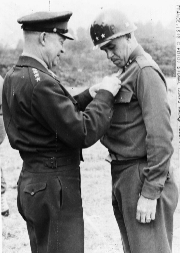 On July 24, 1944, Lieutenant General Omar Bradley receives the oak leaves to his Distinguished Service Medal from his commanding officer, General Dwight D. Eisenhower.