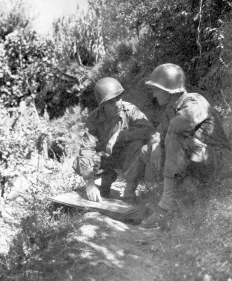 Lt. Col. Darby, commander of the Rangers, confers with Major Roy Murray, a battalion commander, in the hills west of Salerno.