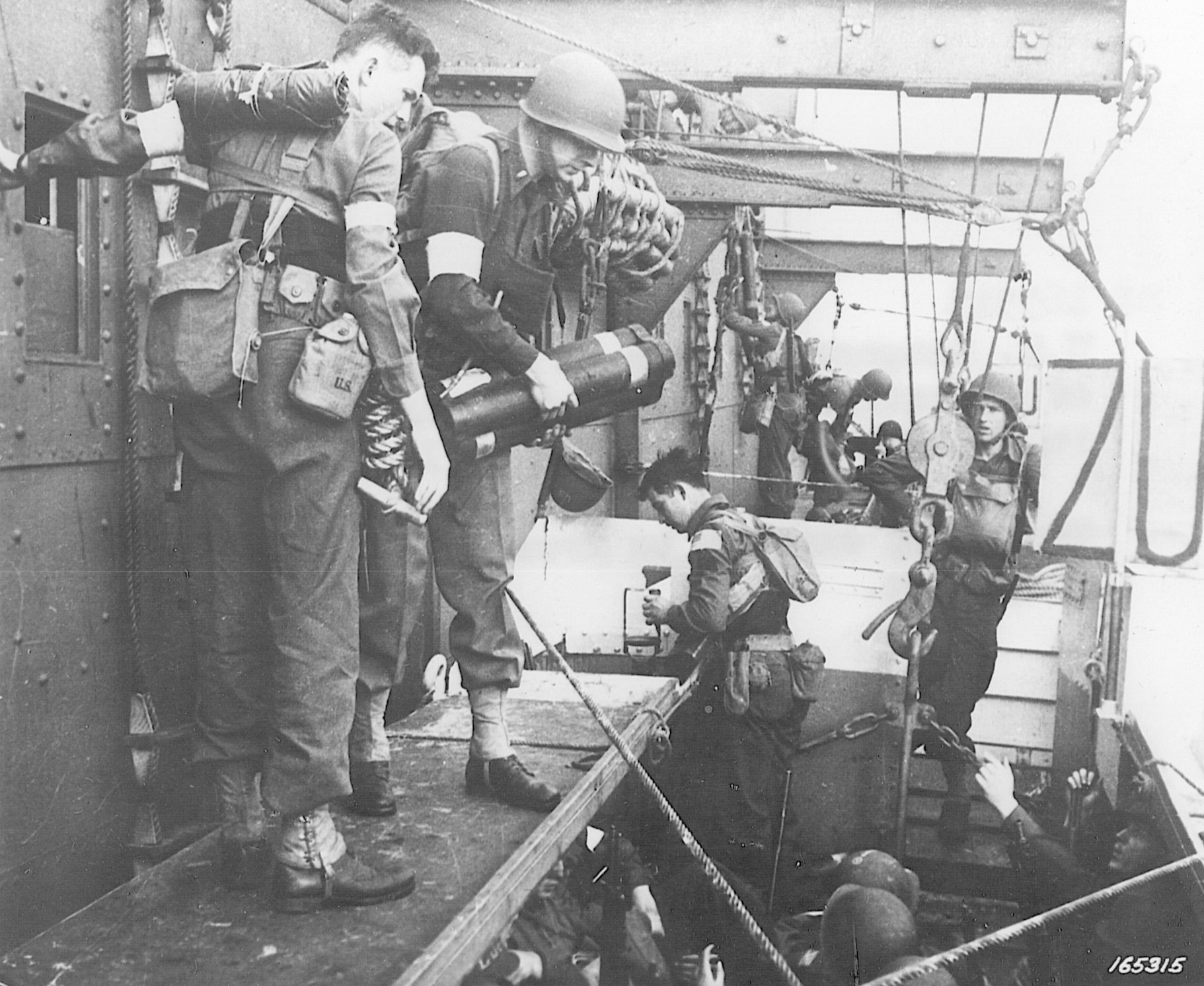 U.S. Army Rangers move themselves and an array of military equipment into landing craft prior to the beginning of Operation Torch. This photo was taken on November 6, 1942, two days before the landings on the African continent. 