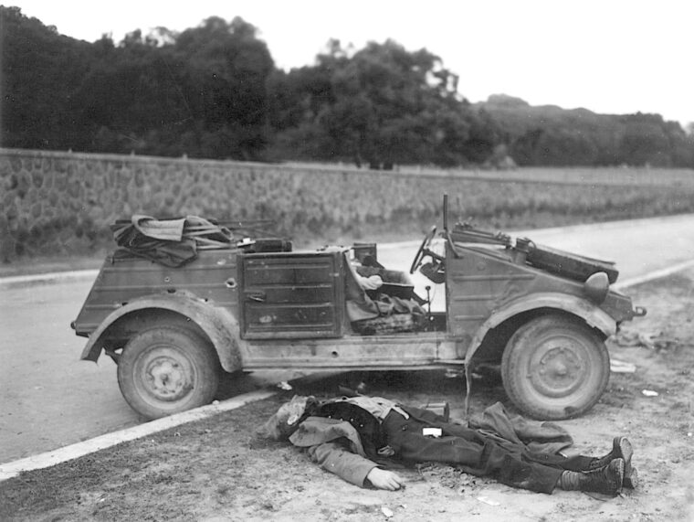 A dead German soldier sprawls next to his vehicle near the Anzio beachhead. Soldiers of the 1st Ranger Battalion caught the victim in an ambush. 