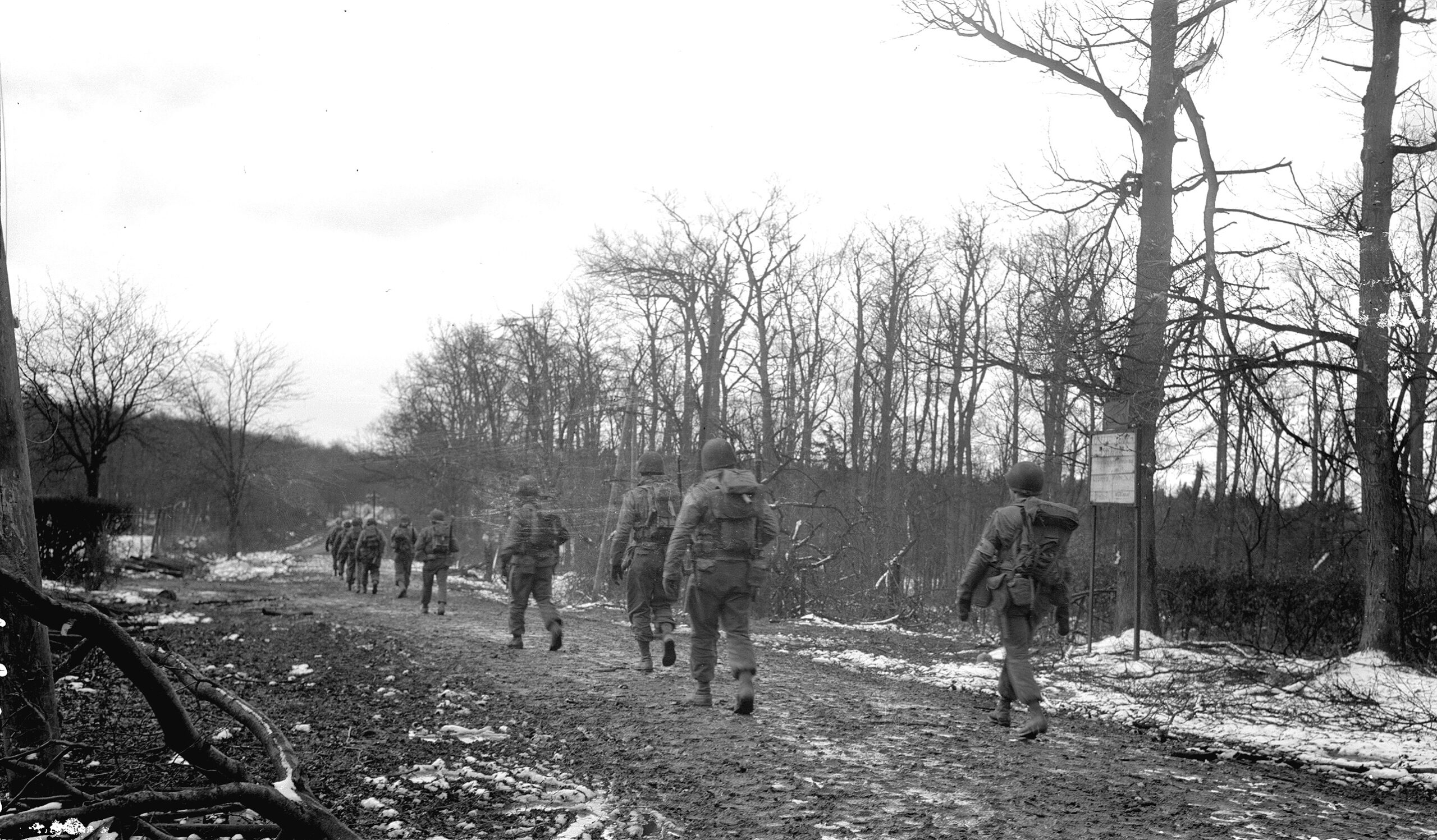 Soldiers of the 2nd Ranger Battalion slog their way along a muddy road in the Hürtgen Forest. These Rangers are on their way to Hill 400, the scene of a fierce stand against repeated German attacks.