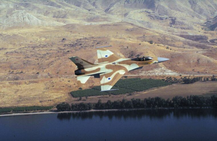 An Israeli pilot in an American-made F-16 fighter jet cruises at low altitude over the Tigris River en route to the al- Tuwaitha nuclear facility near Baghdad.