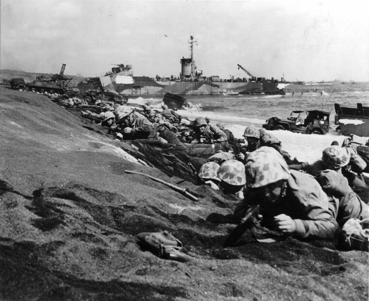 Crowding the beach at Iwo Jima on February 19, 1945, troops of the 4th Marine Division hug the island’s black volcanic sand. Moments after this photo was taken, Japanese artillery and machine-gun fire erupted from hidden positions across the island.