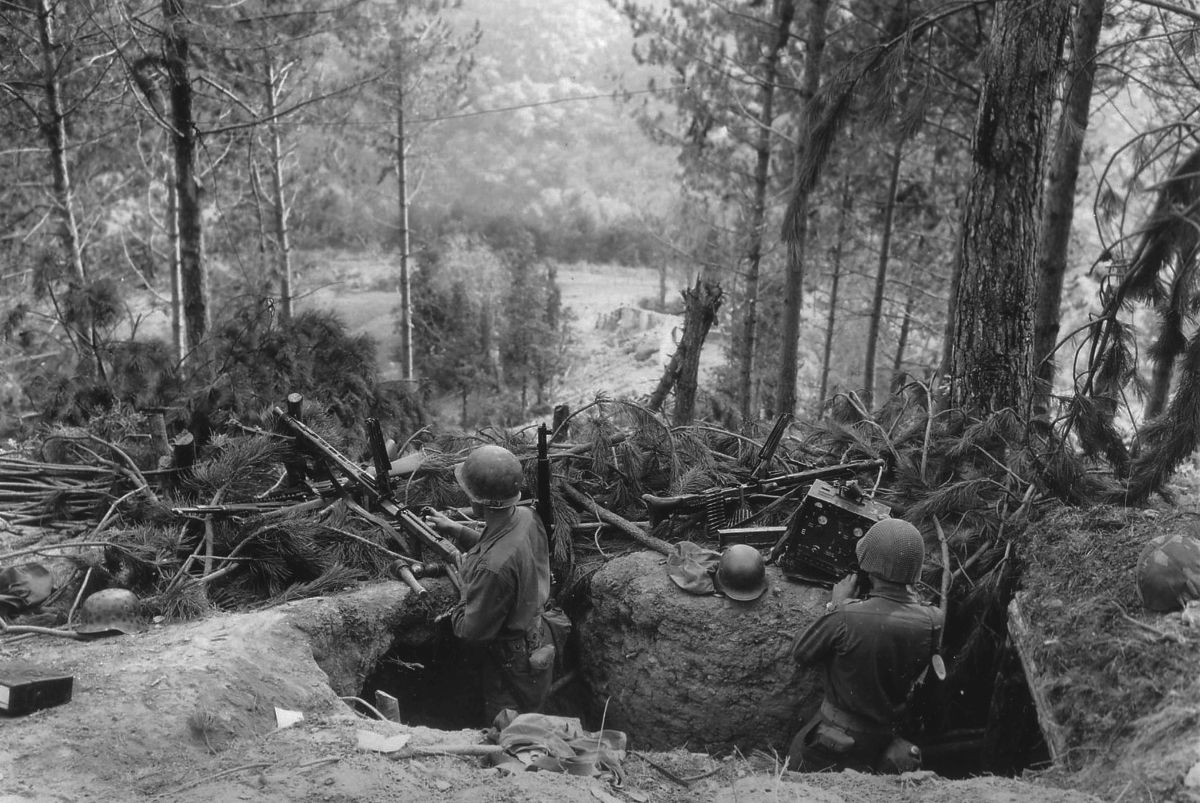 American soldiers inspect a hastily abandoned German machine-gun nest in the Hürtgen Forest. The fighting in the Hürtgen, which began in the autumn of 1944, proved to be some of the toughest in the European Theater.