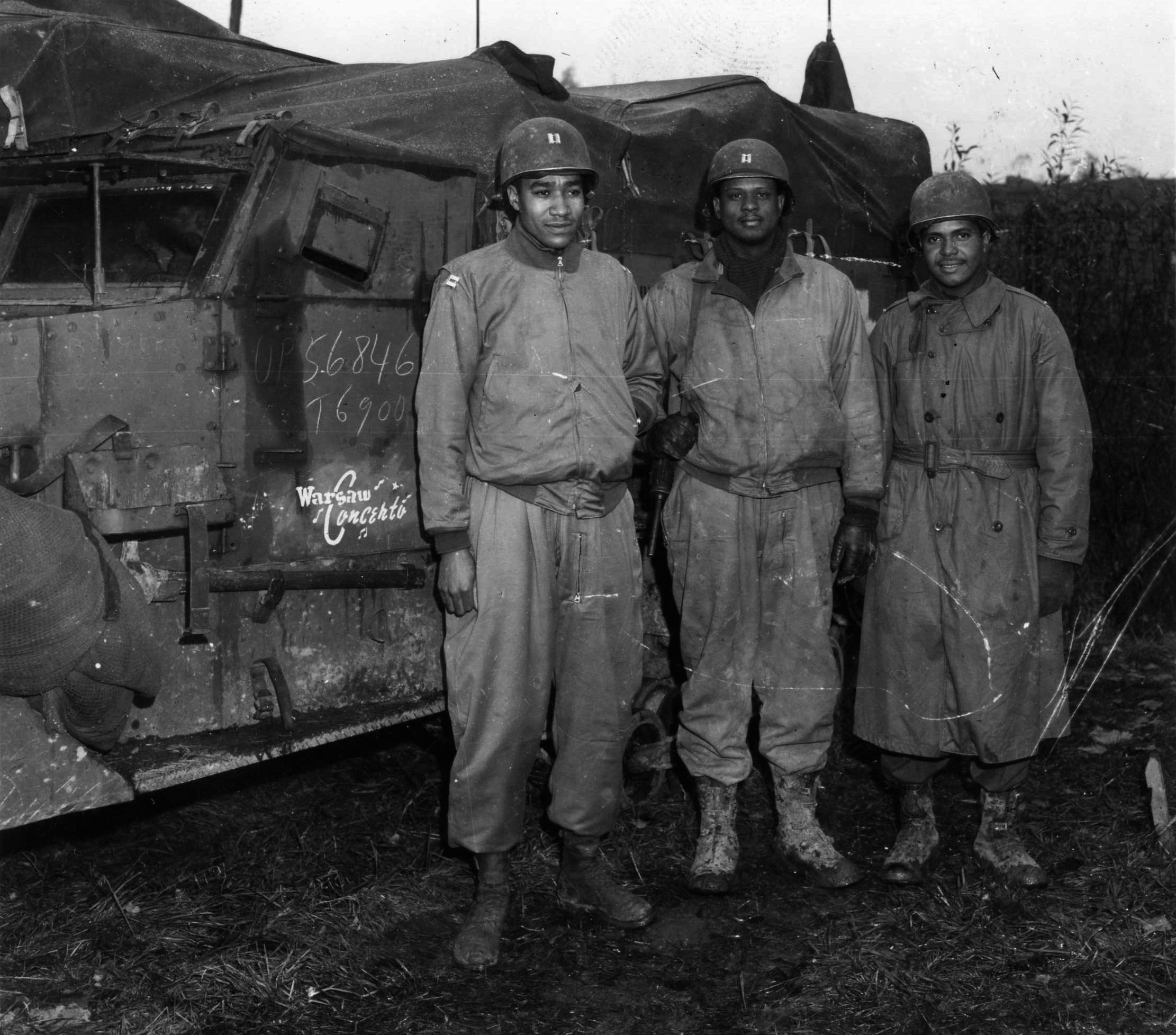 Field officers of the 761st Tank Battalion pause during preparations for upcoming action near Nancy, France, on November 5, 1944. The officers are (left to right) Captain Ivan Harrison, Captain Irvin McHenry, and 2nd Lieutenant James Lightfoot. 