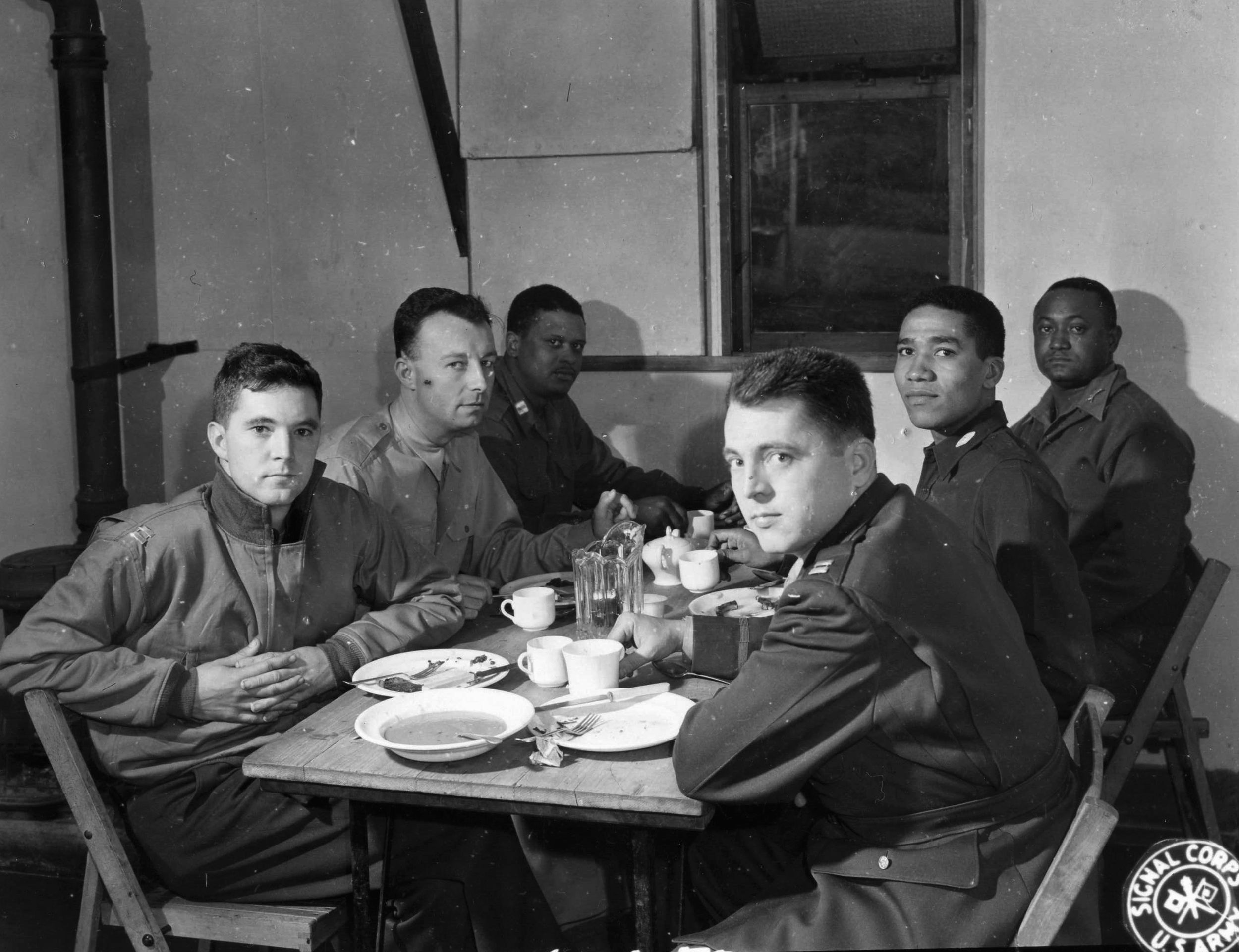 In September 1944, company commanders of the 761st Tank Battalion gather around tables for lunch.  The vast majority of officers who served with black units during the war were white.