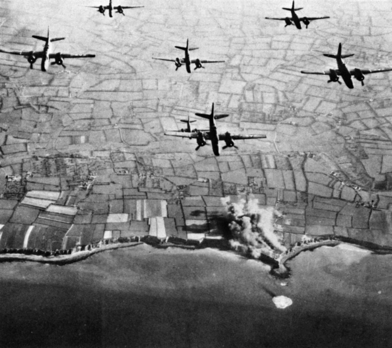 Allied medium bombers of the 9th Air Force execute a tactical air strike against German gun emplacements at Pointe du Hoc on June 4, 1944.