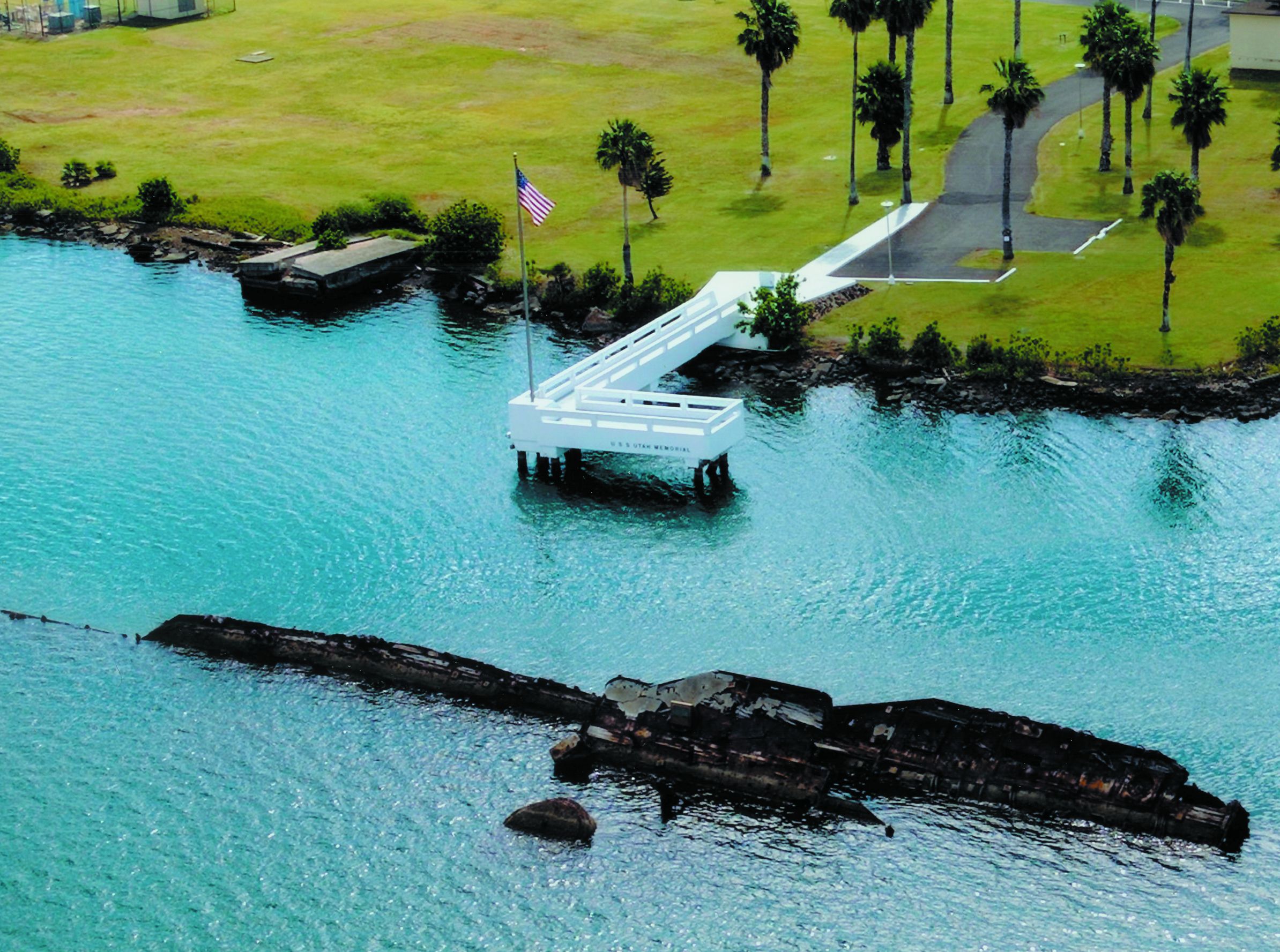 Overshadowed by the stately memorial to the USS Arizona less than a mile away, the simple memorial constructed at the grave of the USS Utah in 1972 commemorates the 54 sailors who lost their lives aboard the vessel on December 7, 1941.