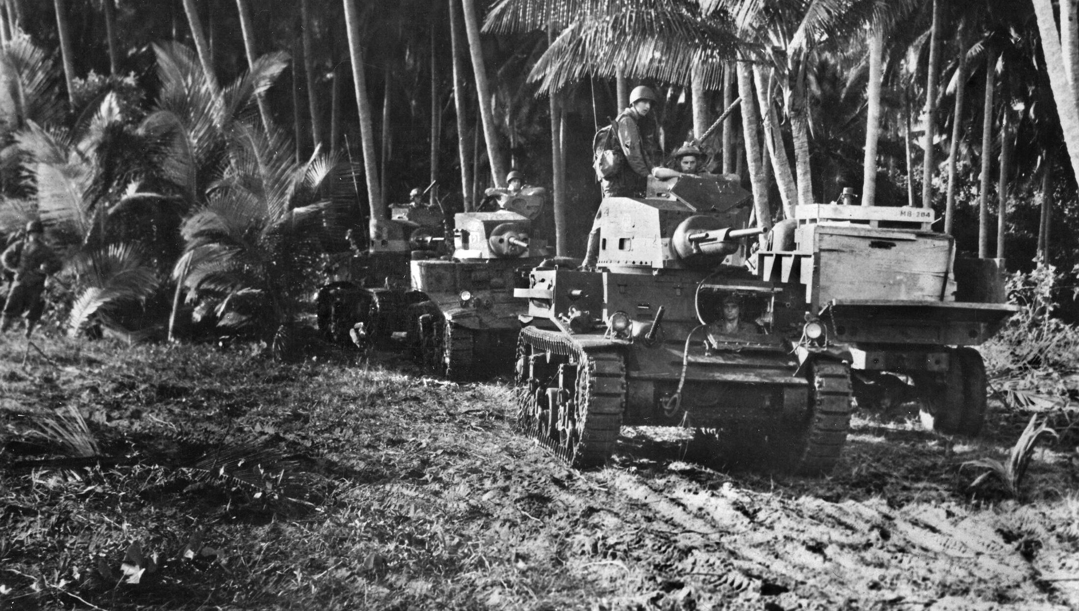 A column of M3 Stuart light tanks moves toward the front line on Guadalcanal. The American tanks were versatile combat assets on the island, their 37mm cannon and machine guns providing mobile fire support.