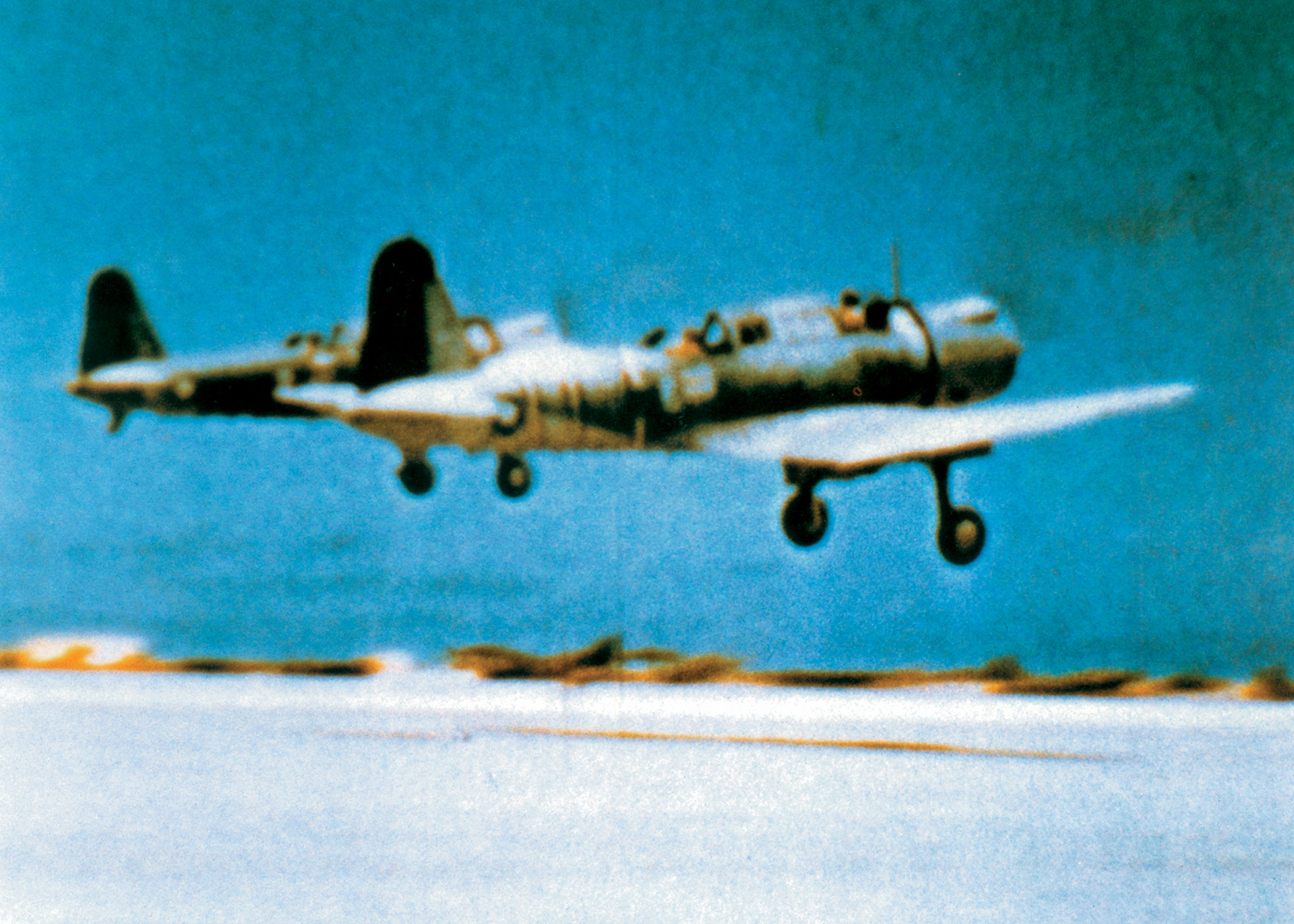 In a still frame from a motion picture, two obsolescent Vindicator torpedo planes take off from Midway on a training mission before the Battle of June 1942.