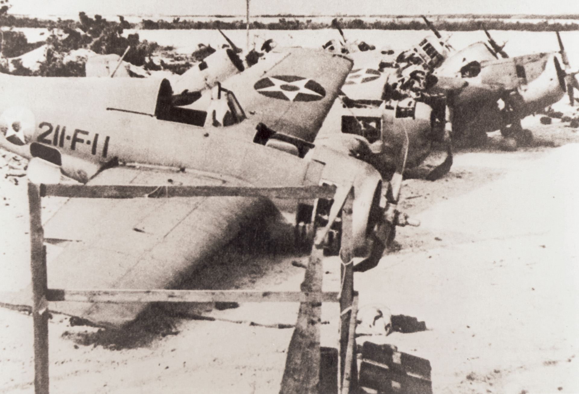 Photographed after Wake Island fell to the Japanese on December 23, 1941, these US. Wildcat fighter planes of Squadron VMF-211 were disabled during the fighting.
