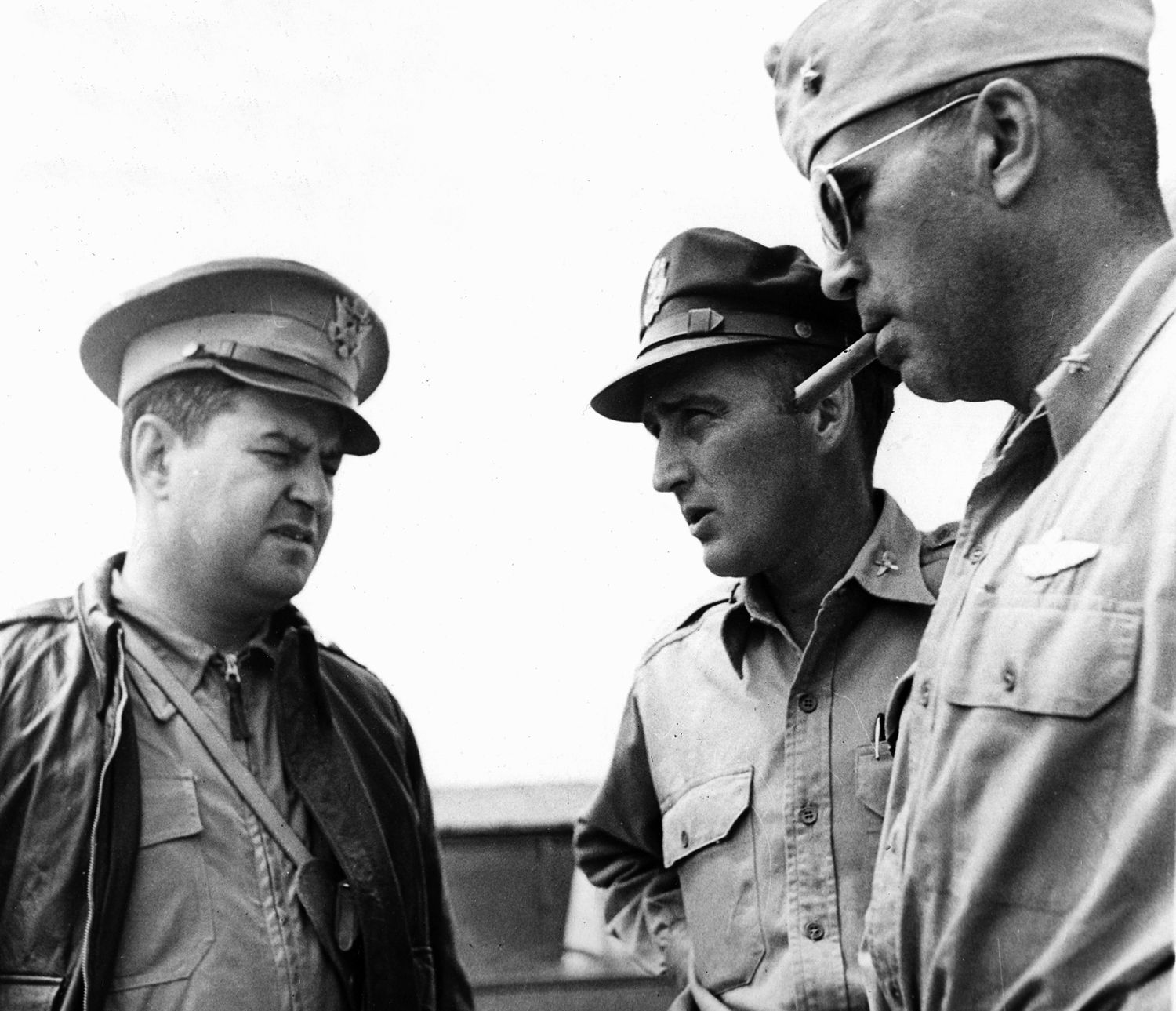 Standing left to right, Major General Curtis LeMay, commander of the 20th Bombardment Group confers with Colonel Dwight O. Monteith, forward echelon commander of the 20th, and Brigadier General La Verne “Blondie” Saunders at a base somewhere in China in 1944.