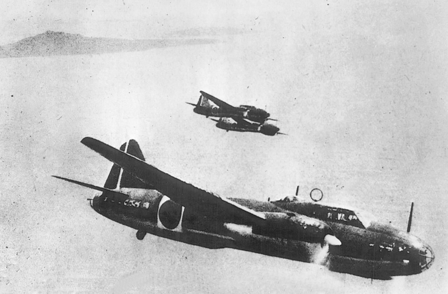 Japanese Mitsubishi G4M2 Betty bombers, similar to those used in some attacks against American air bases in the Marianas, wing their way toward a target. The vulnerable Betty was later replaced largely by the twin-engined KI-67 Hiryu, codenamed Peggy by the Allies.